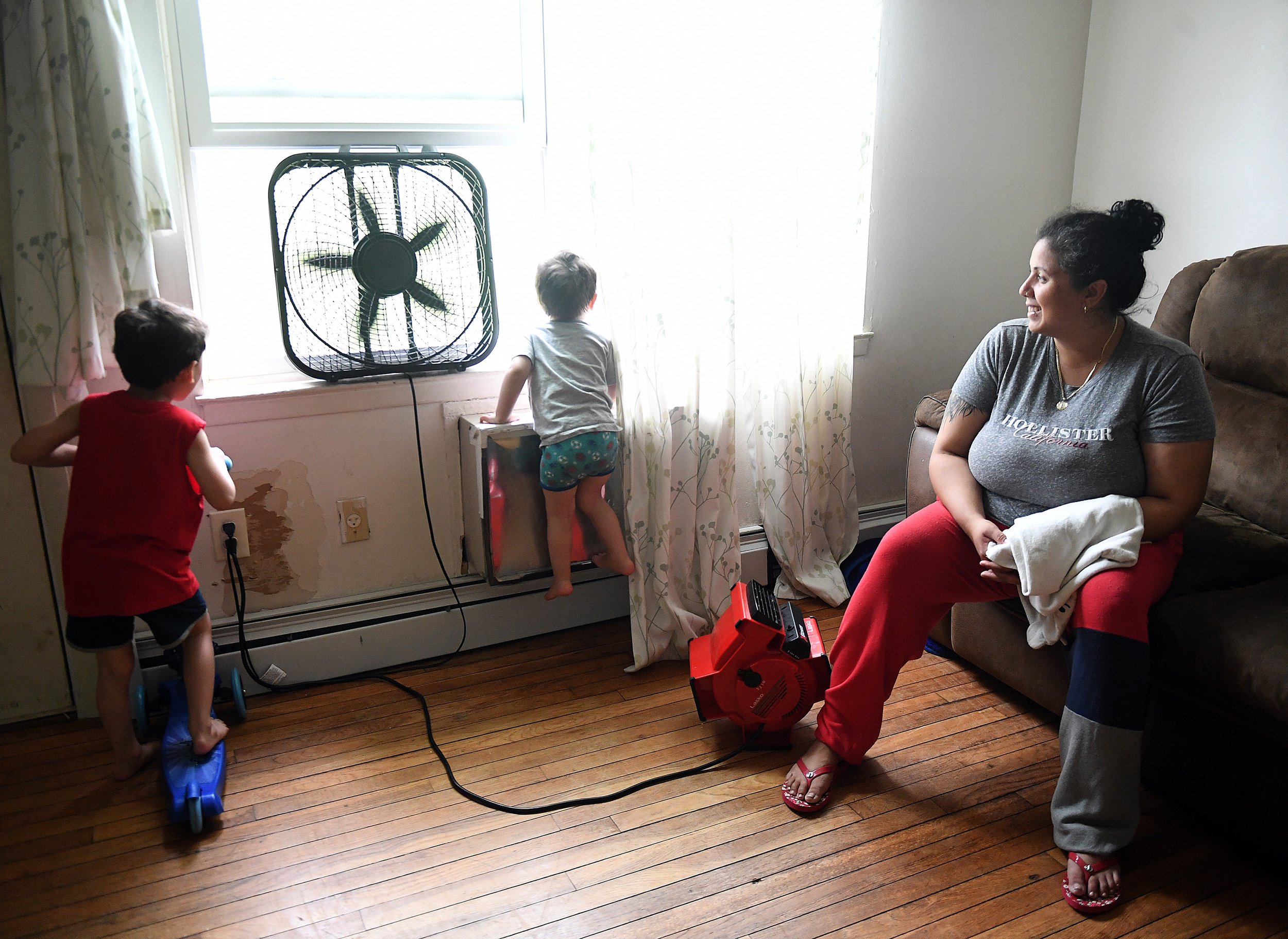  Christine Santos looks on as her sons watch out the window of their Branford Manor home in Groton Friday, June 17, 2022. She said she feels stuck at Branford and doesn’t see many other affordable housing opportunities in the area. (Sarah Gordon / Th