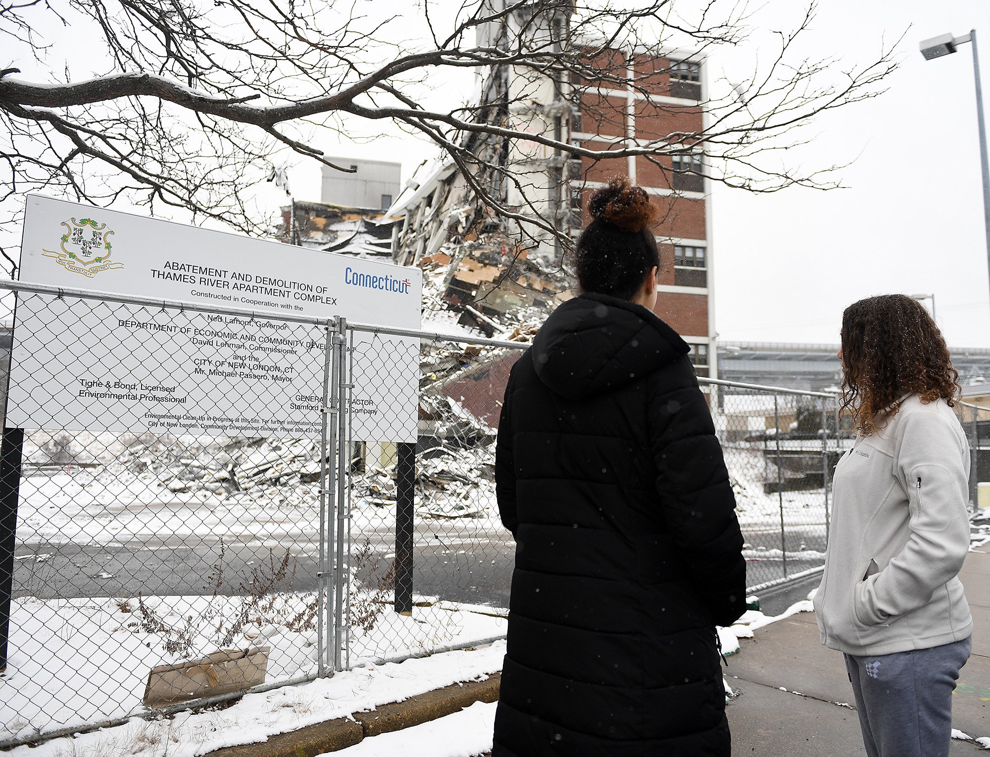  Sisters Samarie, 18, and Tayana, 16, Delgado stop by the Crystal Ave Towers to check out demolition with their mother Maribel Gray, not pictured, Sunday February 13, 2022. Maribel had her daughters as a teenager and lived in the the complex with the