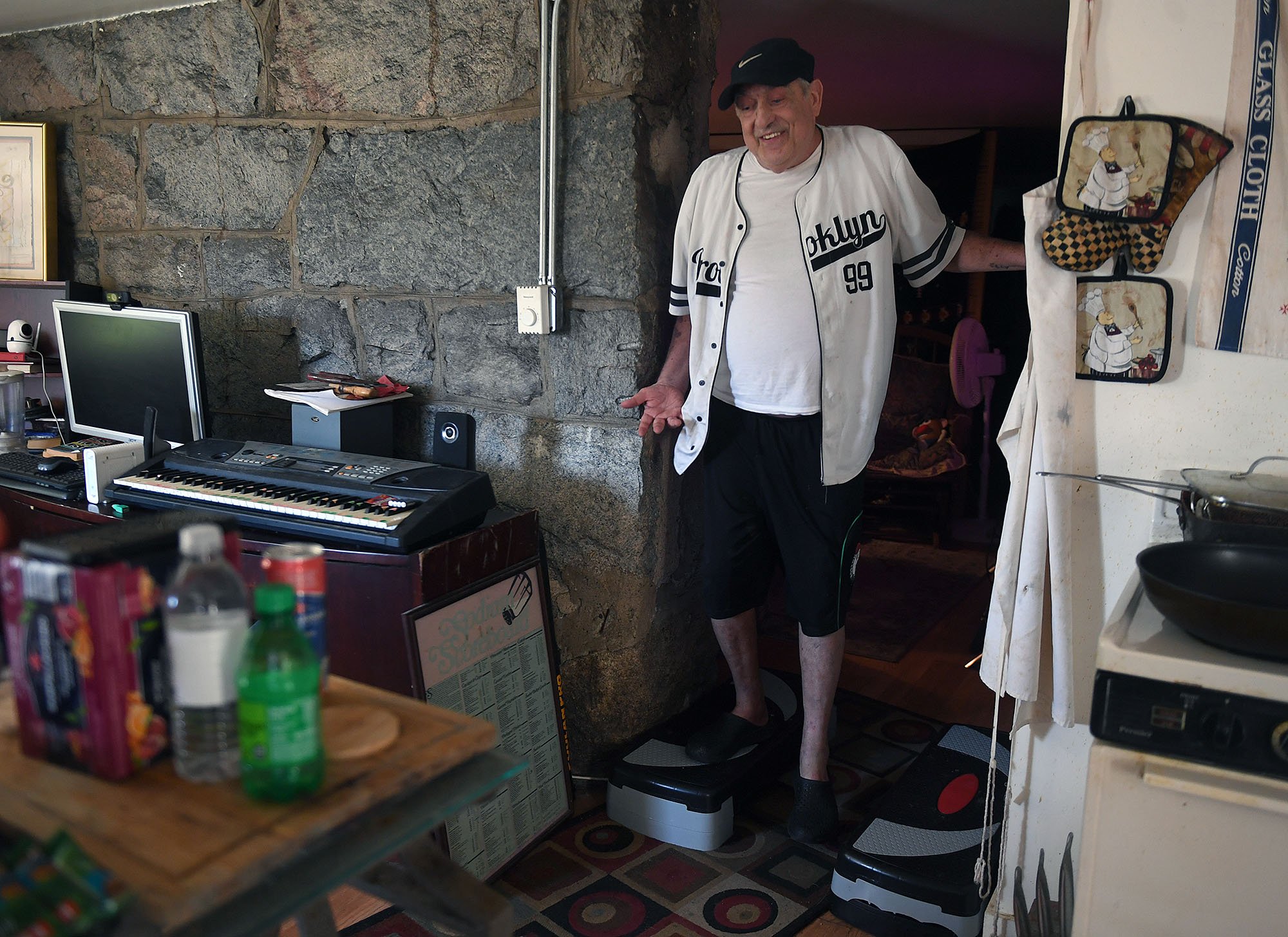  Tom Sweeney does step exercises in the doorway at his apartment on Riverview Avenue in New London Thursday, September 1, 2022. The landlord has recently raised the rent and Tom has applied for senior housing and Section 8 with the NL Housing Authori