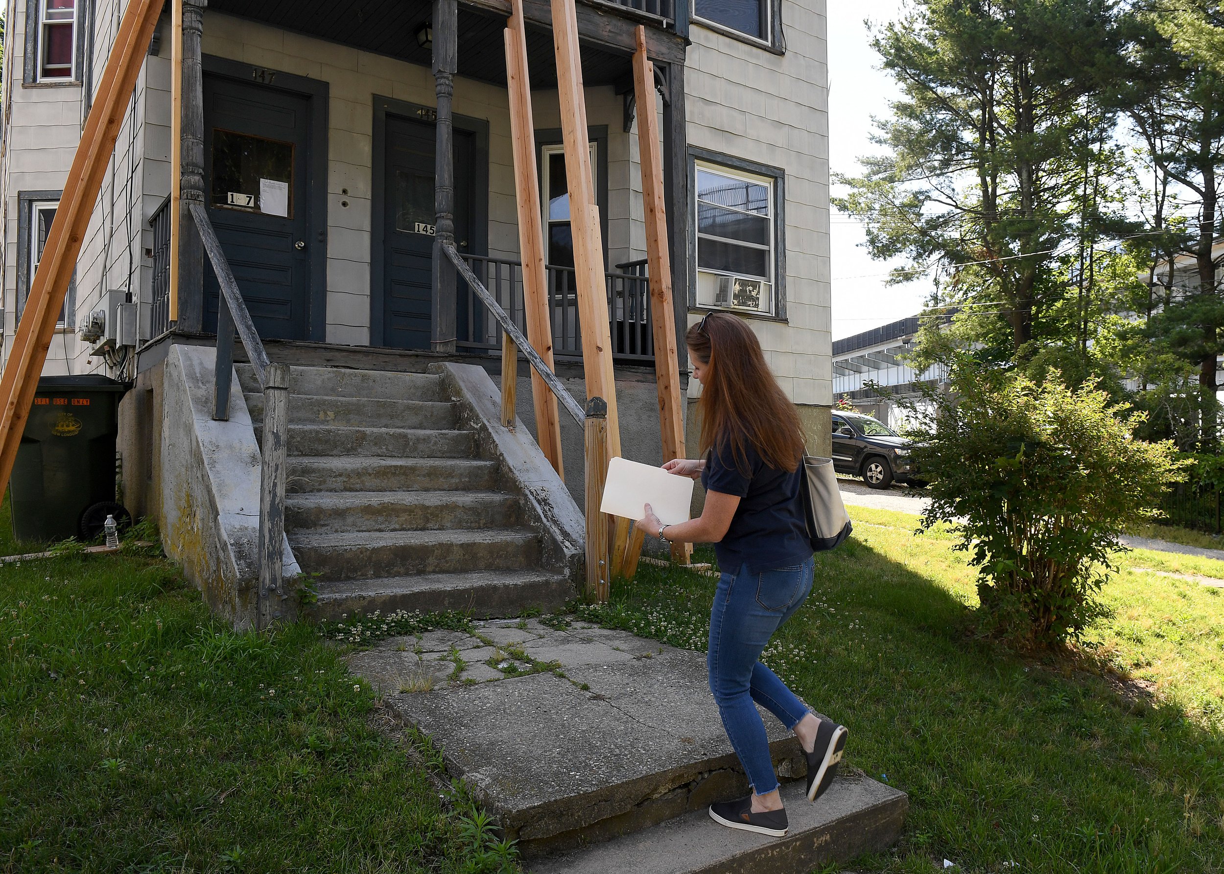  Cheryl Haase, Environmental Technician with the Ledge Light Health District, walks up to a home for a mold inspection on Crystal Avenue in New London Thursday, June 30, 2022. (Sarah Gordon/The Day)  
