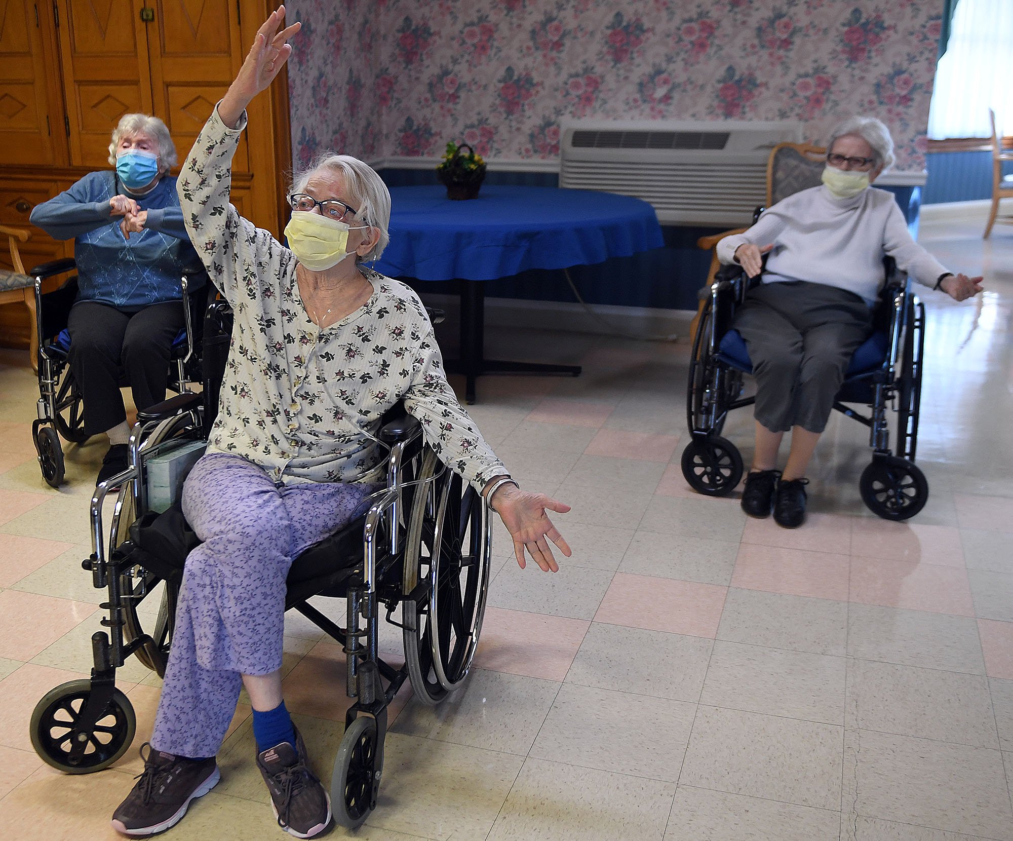  Residents, from left, Marge Roggero, Pat McFarlane, and Kathryn Bergeeron participate in a chair yoga class at Beechwood in New London on Wednesday, March 10, 2021.  The nursing home has recently restarted indoor group activities in a small socially