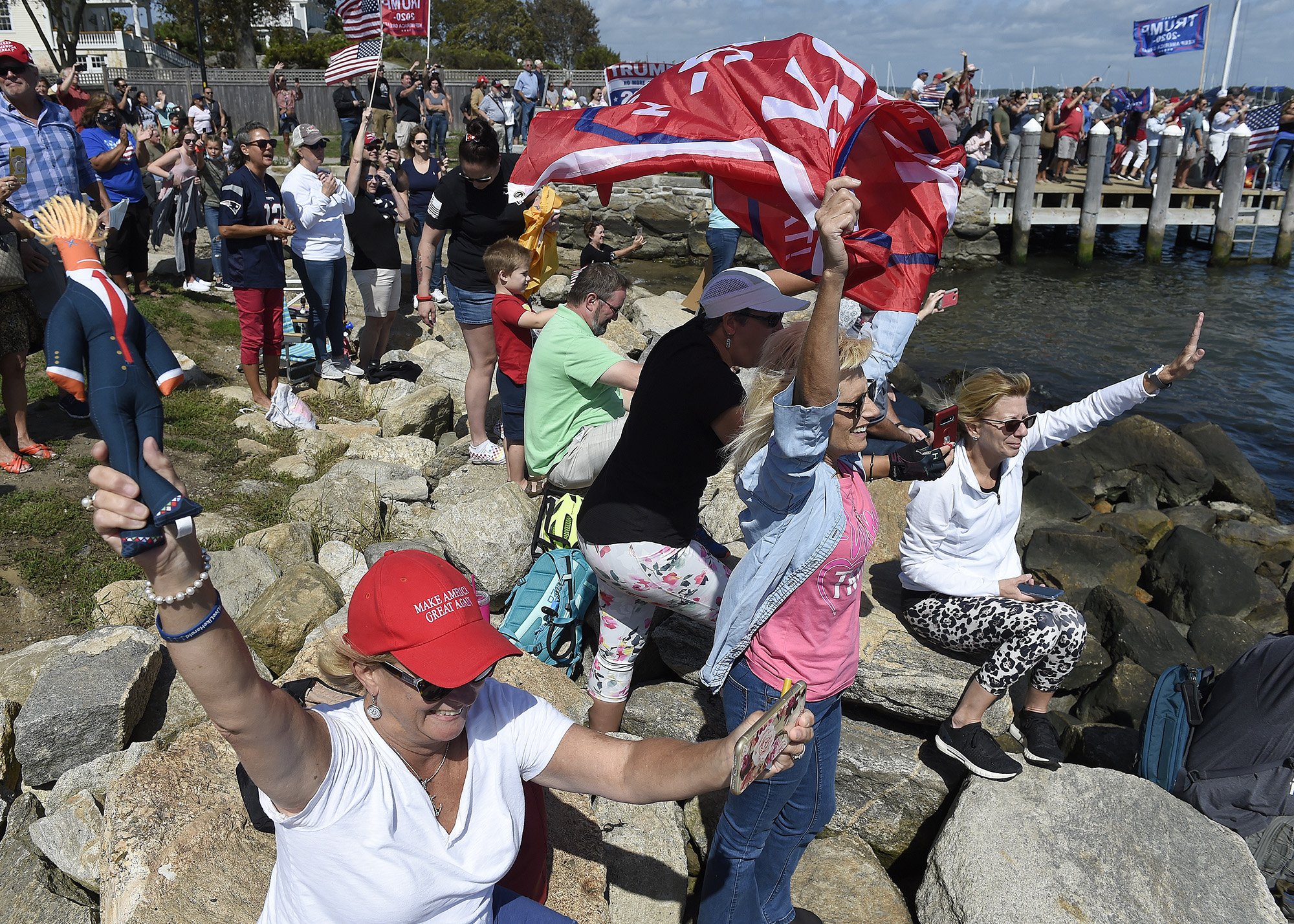  Maureen Lawton, center, of Naragansett, holds up a Donald Trump doll as she cheers during the Trump Boat Floatilla along the Mystic River on Sunday, September 13, 2020. More than 800 boats flying pro-Trump flags and carrying groups of cheering suppo