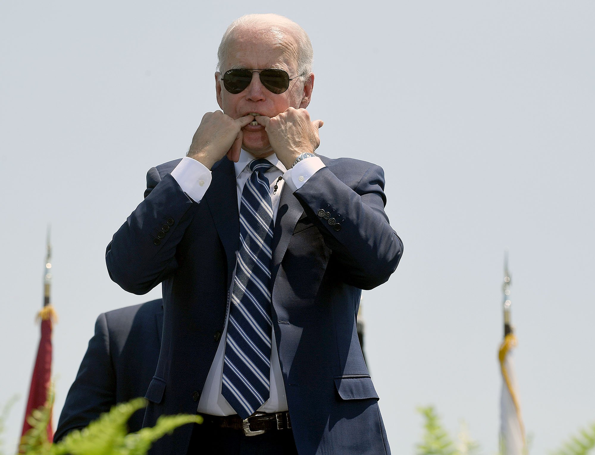  U.S. President Joe Biden puts his fingers in his mouth to whistle during the United States Coast Guard Academy 2021 Commencement Ceremonies at the school New London on Wednesday, May 19, 2021. (Sarah Gordon/The Day)  