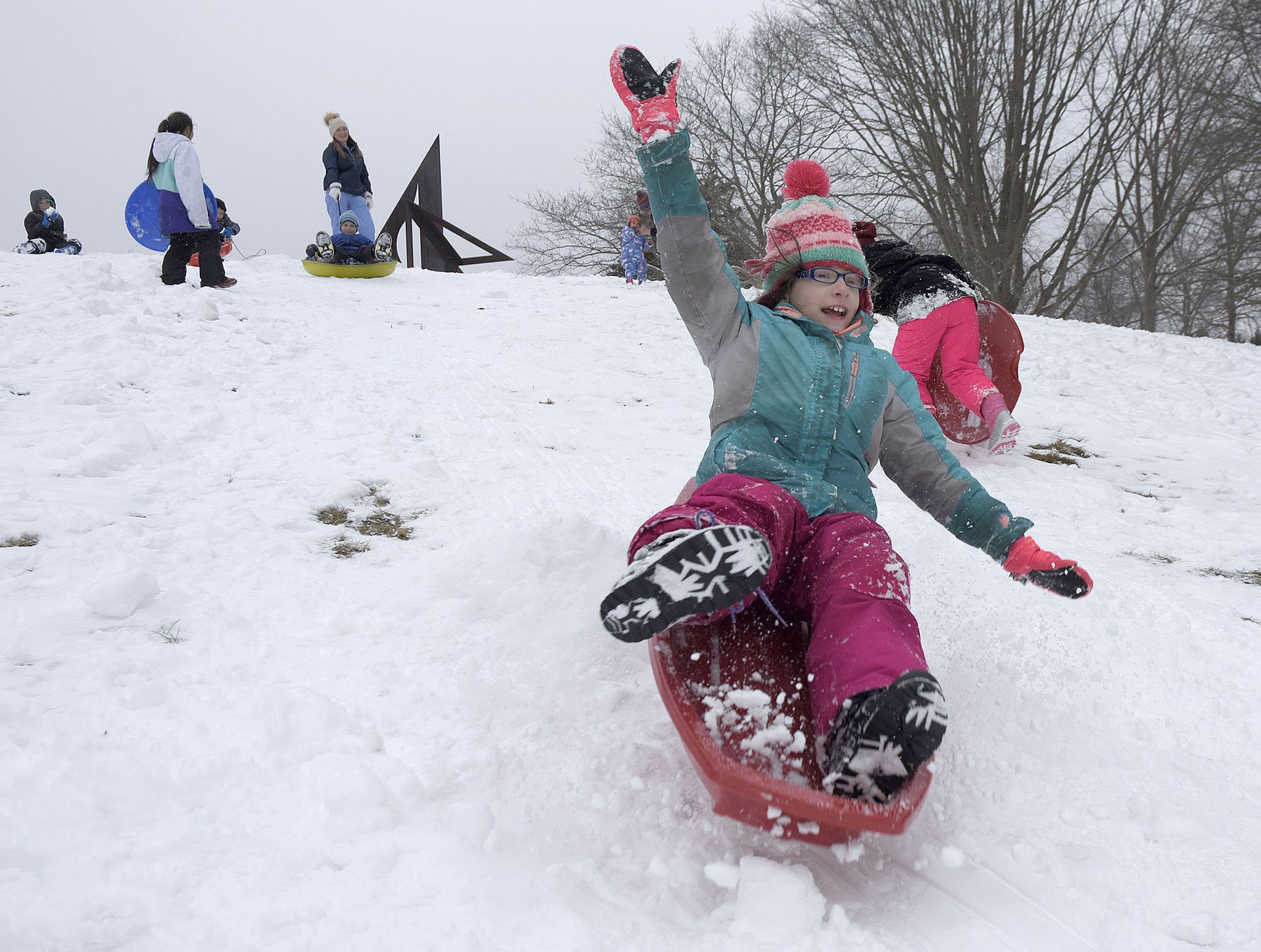  Sophie Gualtieri, 9, of Waterford, looses her hold on the sled as she goes over a jump on the hill at Lyman Allyn Art Museum on Tuesday, February 8, 2021. There was a small crowd of kids and parents enjoying the hill Tuesday as New London Public Sch