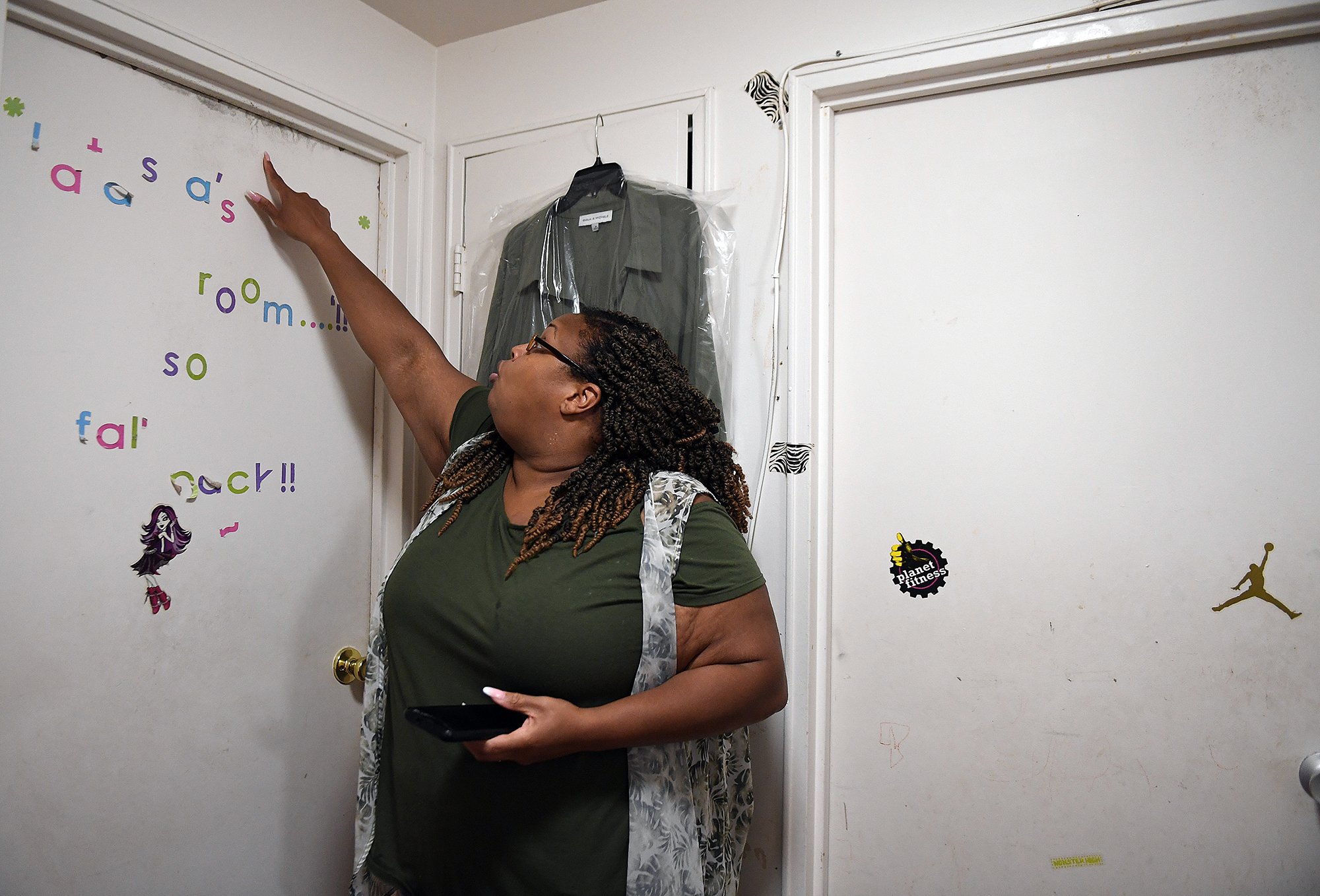  Latasha Burage points out black mold on the bedroom doors at her Branford Manor apartment in Groton Wednesday, September 1, 2021. (Sarah Gordon / The Day)  