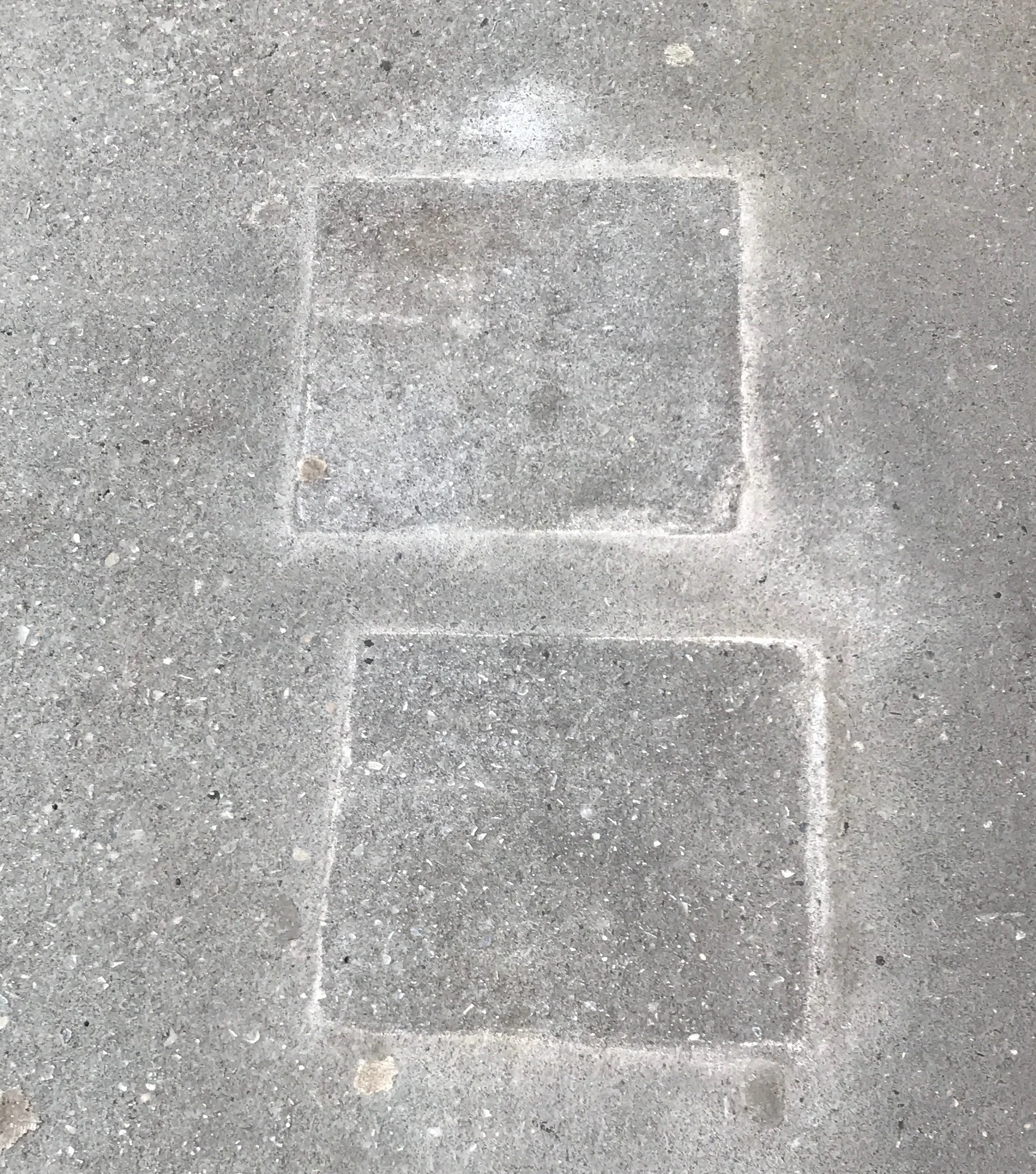 Two blocks etched into the sidewalk along West 72nd Street.