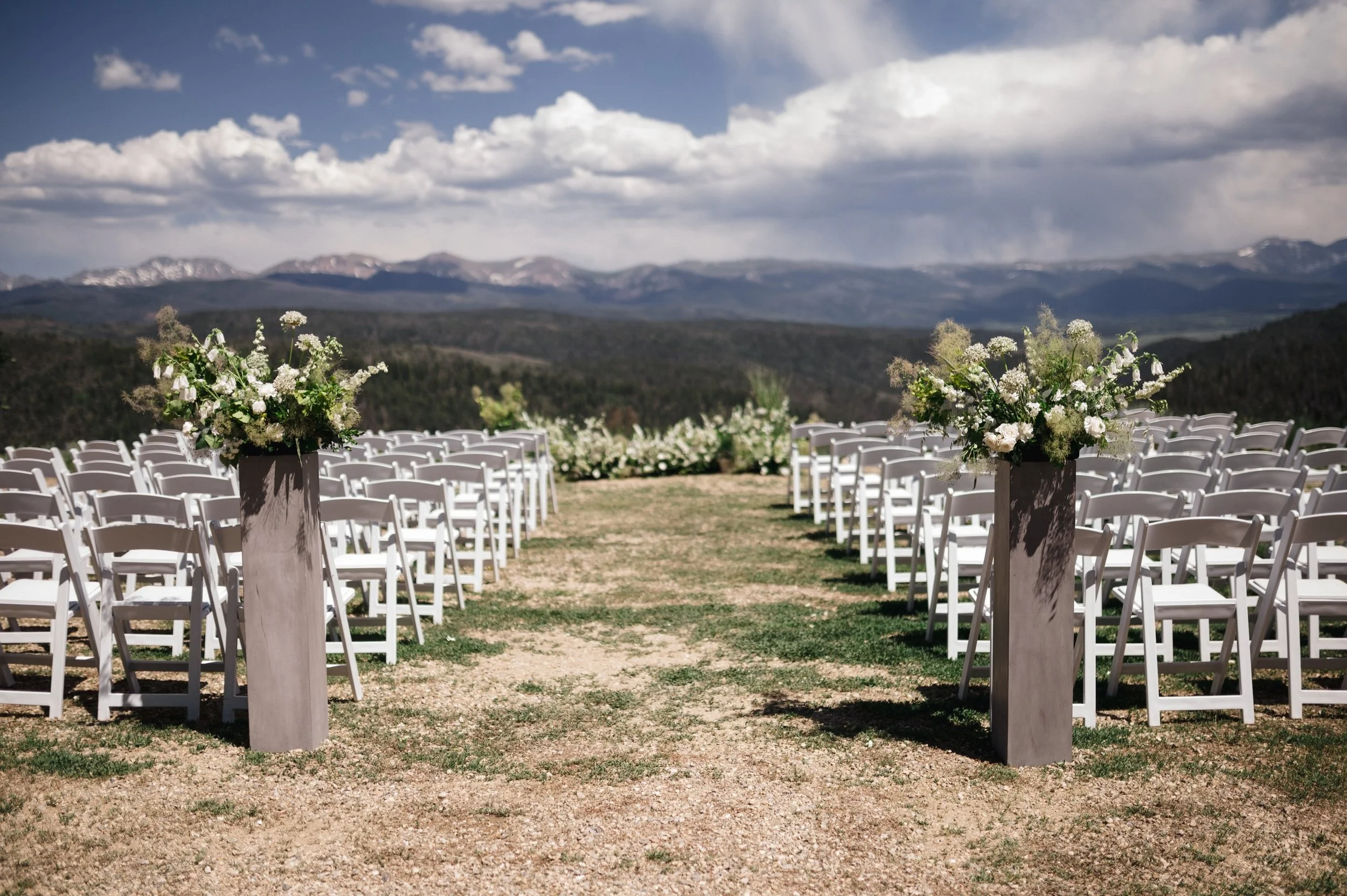 Concrete pillars and making the couple look like they&rsquo;re standing in the middle of a meadow instead of a wooden platform. @mjmdesignsllc helped bring our natural yet intentional design to life.
