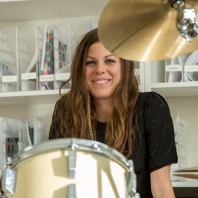Mindy Abovitz is a self taught drummer and drum machine programmer with a Masters in Media Studies from The New School for Social Research. She started Tom Tom Magazine in 2009. She hopes to impact the music industry through print media, new media, showcases, panels and community interactions and see a 50% increase of female drummers in the next ten years. The magazine has a feminist mission and seeks to raise awareness about female percussionists from all over the world and hopes to inspire women and girls of all ages to drum, while strengthening and building the community of otherwise fragmented female musicians. 