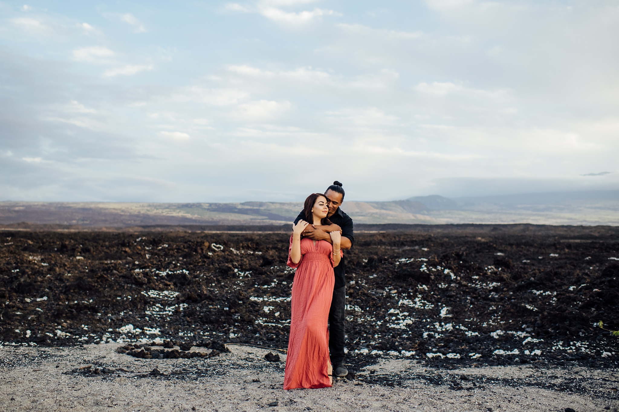 couple embracing on lava rock