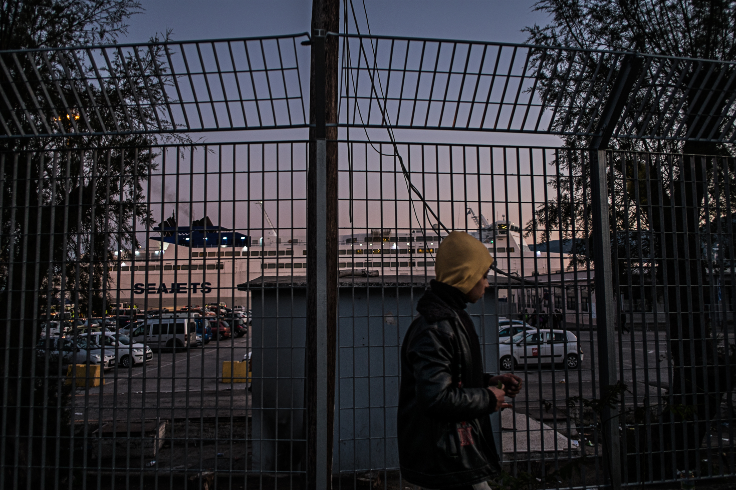 As the sun is coming down, most refugees are getting ready in the main harbor to embark on the evening ferry to Athens.