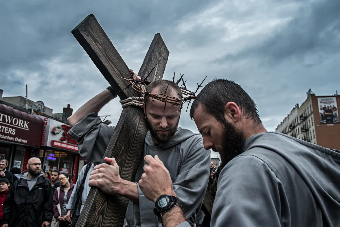 As it is too heavy to carry all the way, the cross is being passed among the St.Franciscans Friars and their followers. A significance for the Friars in remembering Jesus's suffering and a statement that we shall all help and support each-other.