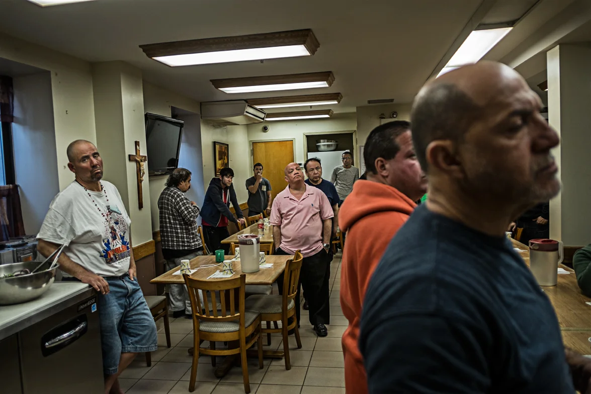 The Franciscan Friars hosts over 60 homeless men in their shelter next door who are in critical need of assistance, due to substance abuse, financial instability, criminal or other social issues. Inside the dining room shelter. A religious speech is made by father Louis before dinner is served.