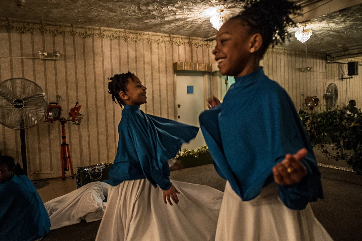 Emma and her friend having fun in their dancing outfit, just a few minutes before the performance for the Sunday service .