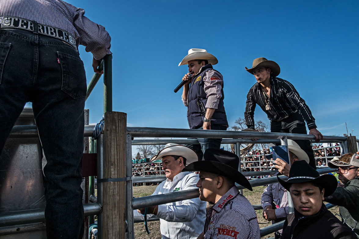 Annoucing and preparing for the next rider to get on the bull.