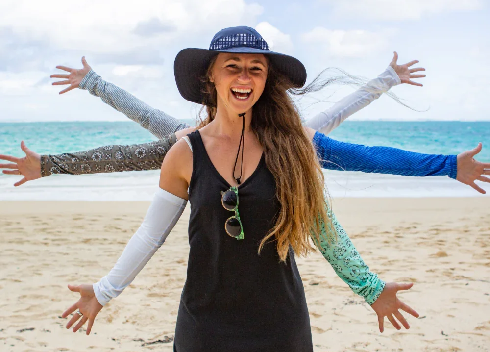 a woman stood on a beach wearing UV Cool Sleeves