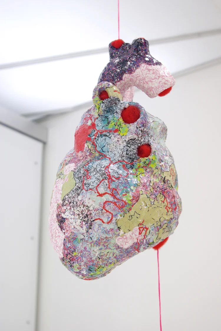 Detail of Incidentalomas for group exhibition Paper City (Mixed Greens Gallery, NYC). Paper mache heart covered in thousands of dots punched from original digital print, twine. 2008.
