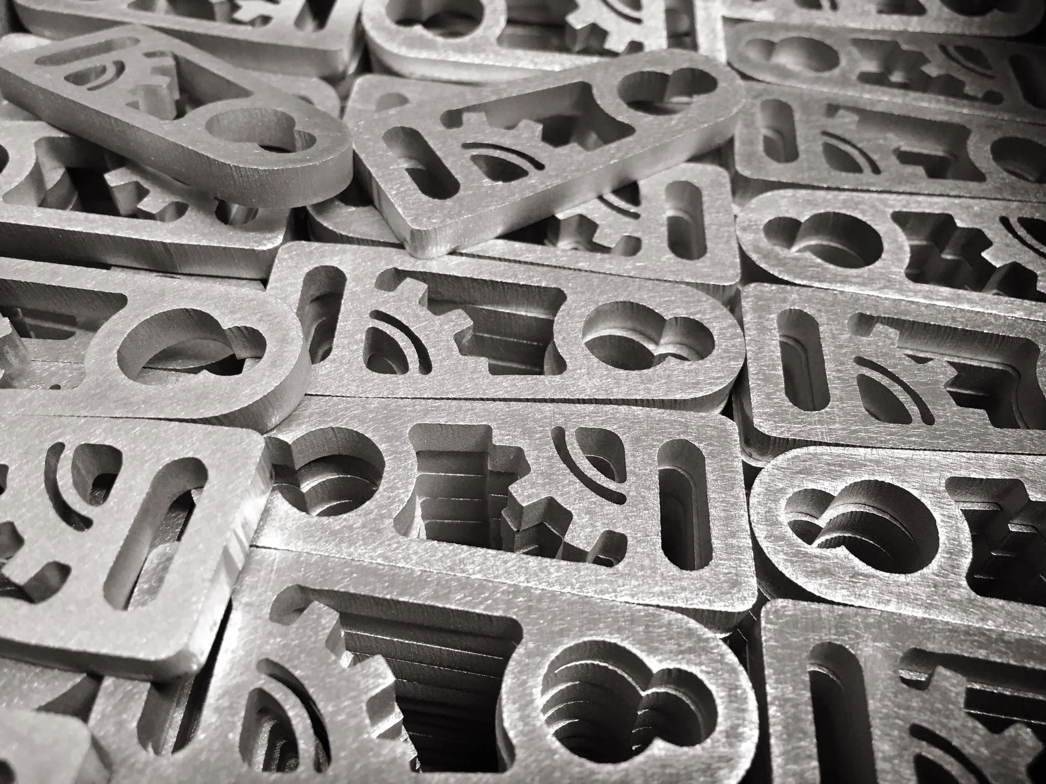 Abrasive CNC Waterjet cut latch pulls in raw form. Headed to tumbling and anodizing!