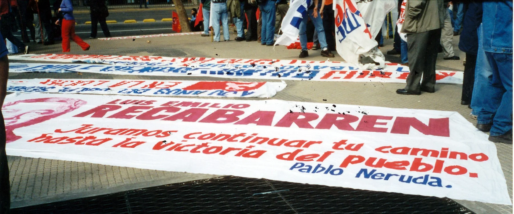Plaza de los Héroes. Banner displayed in preparation to march in remembrance of the disappeared Quotation from Pablo Neruda pledging to follow Recabarren’s (prominent labour figure of the revolutionary left) path until victory.