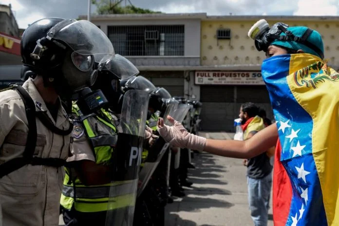 Venezuelan Opposition Protester confronts the Police