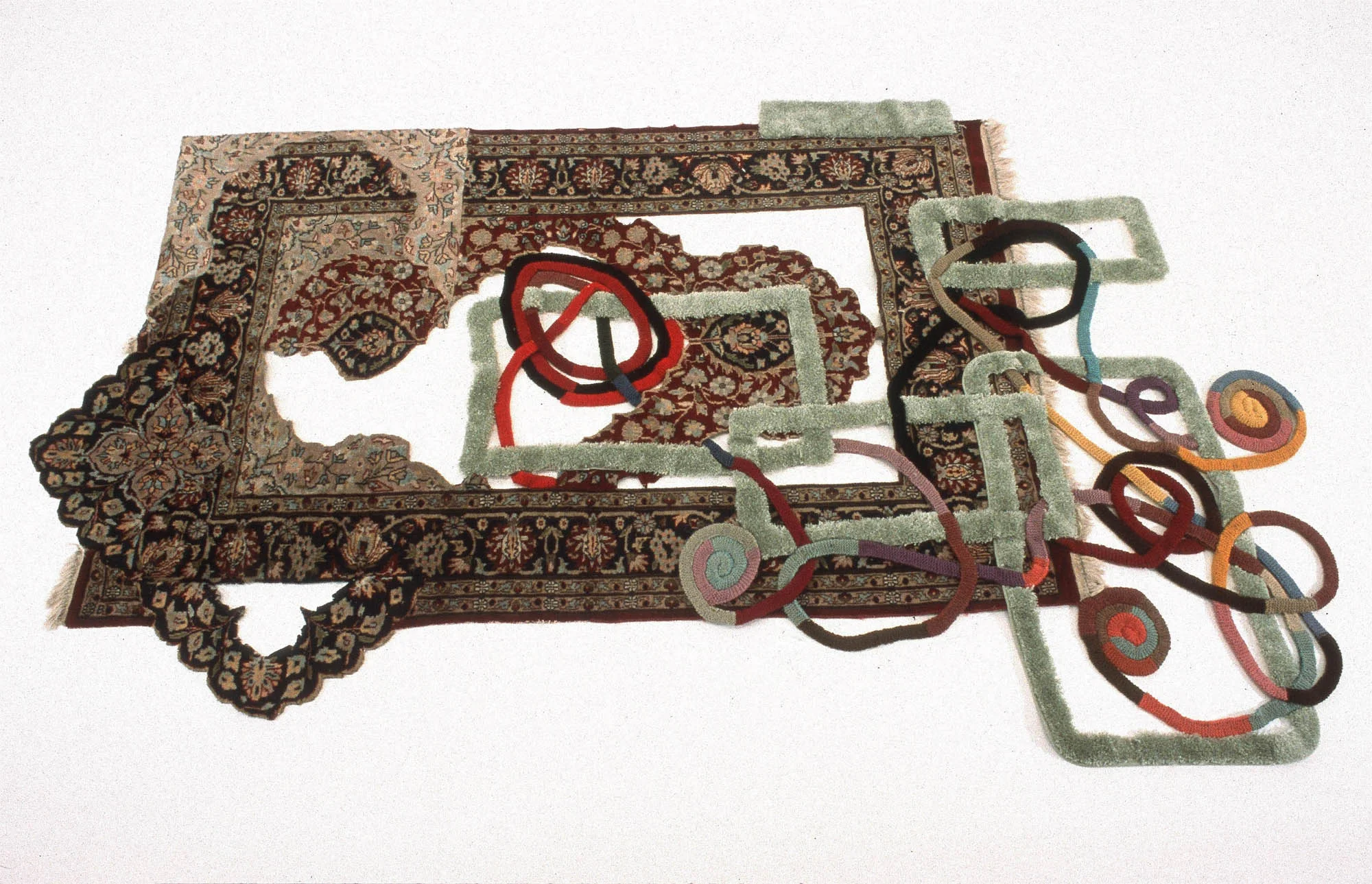 Twine, 2002, oriental rug, bathroom rug, seat covers, thread, approx. 6.5x6" This piece may be displayed on the wall or the floor.