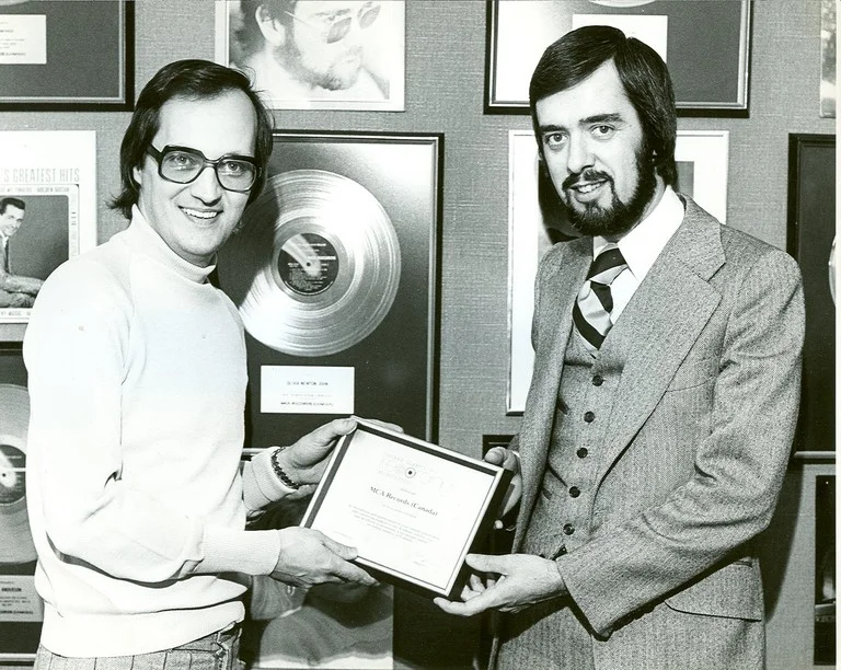 Former manager Mel Shaw (left) receives award 1973