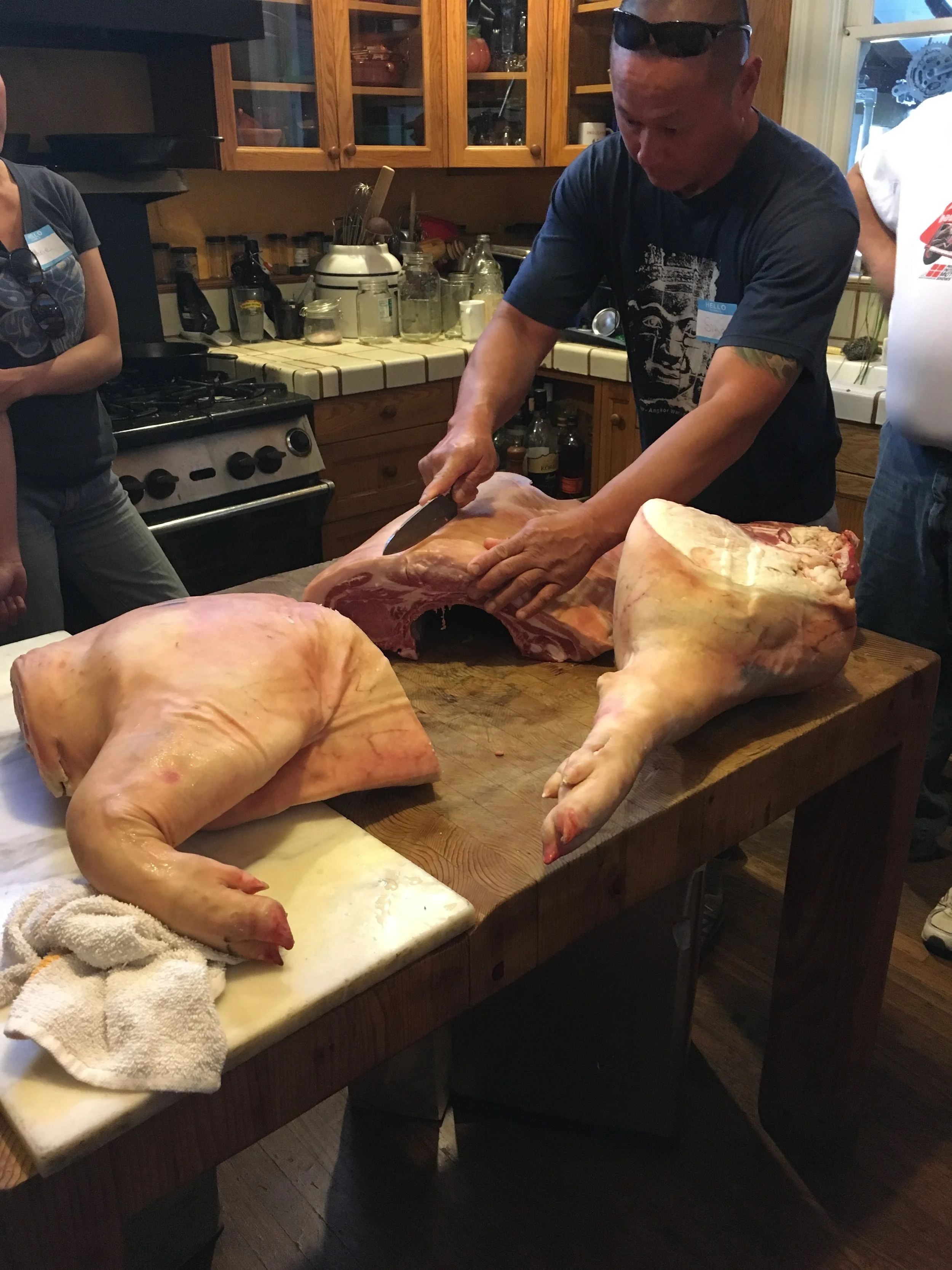Shoulder quarter on the left, leg quarter on the right, and a classmate separating the loin and belly.