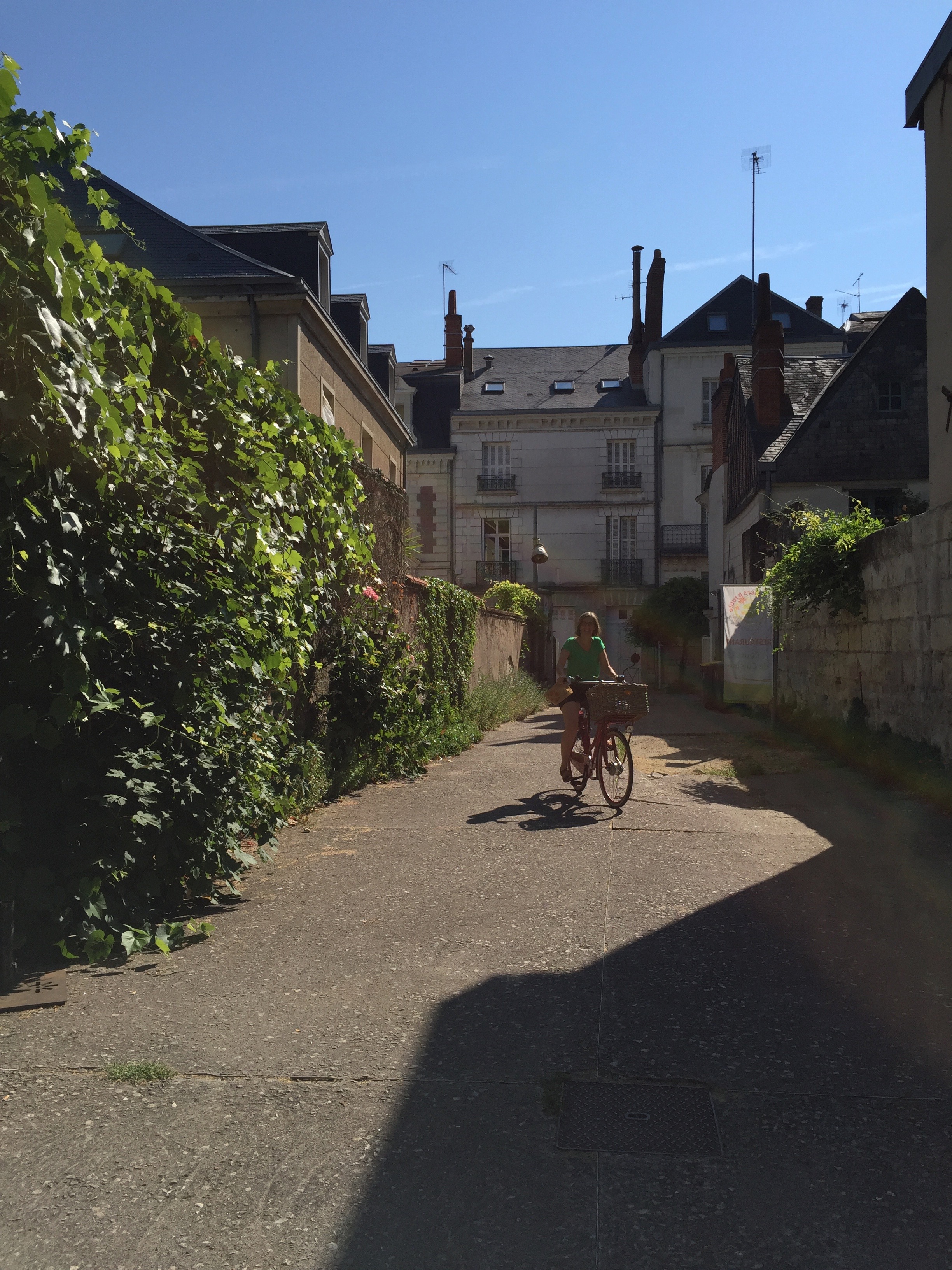 Frederique, our chef, pulling up on her bike. She goes to market every other day and fills her bike basket with ingredients that she uses in her restaurant.