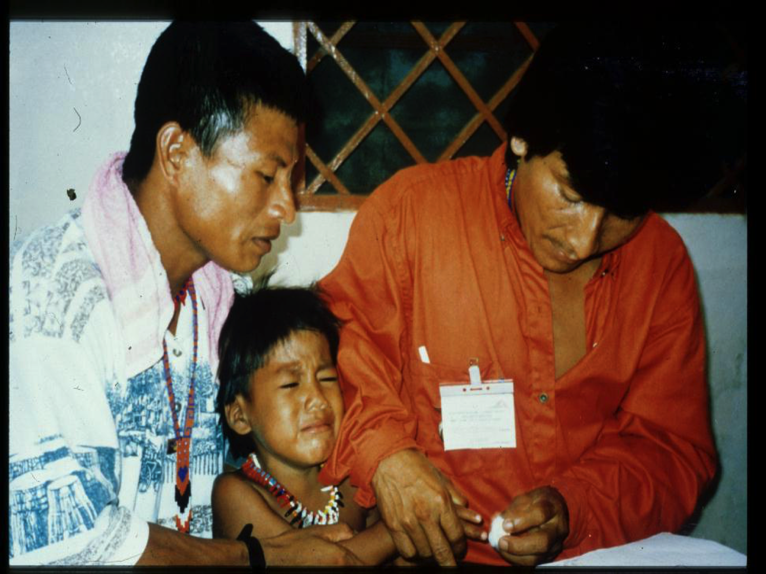 An indigenous boy (unhappily) gives our health workers a drop of his blood for a practice smear.