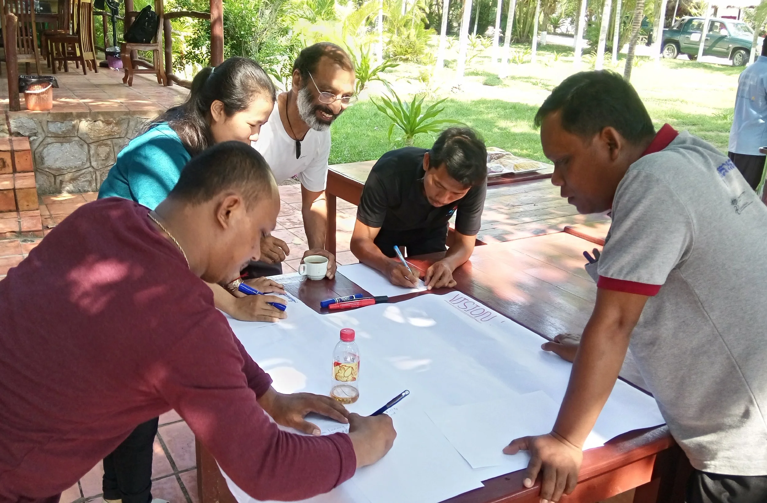 Its all about vision- what we see as real change.... and participation. I loved this workshop's setting- a whole team, working outside as waves lapped on a rocky shore behind us and breeze tousled scraggly coconut palms above. .