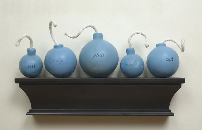 Da Bomb Squad, 2003: wax, cotton cord, applied text, wood; 13 x 30 x 7 inches