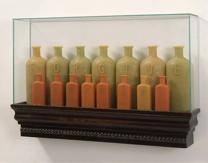 The virtues and vices of history, 1998: wax, wood, , metal leaf, glass; 13 x 24 x 4 inches. Back row: forgive. Front row: remember.