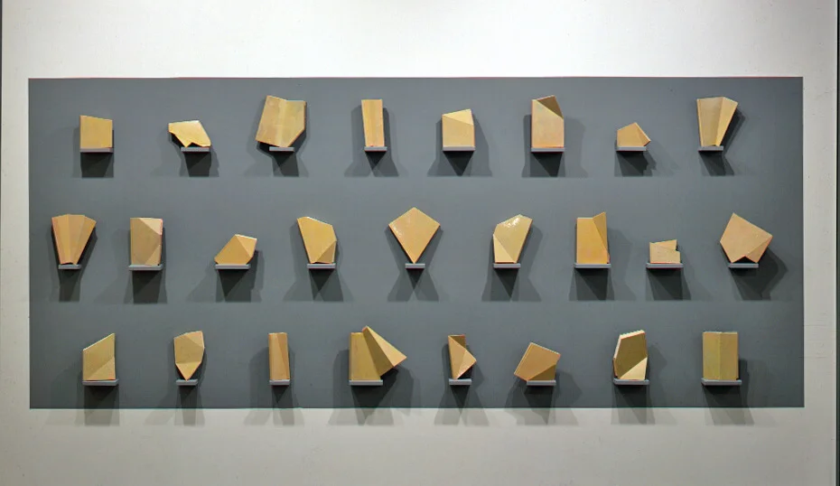 Character Study, 1990: books, oil paint, wood, 140" x 70" x 5". 26 book ‘characters’ imply both letters and individuals; the ‘skin’ of the book pieces is painted like—skin.