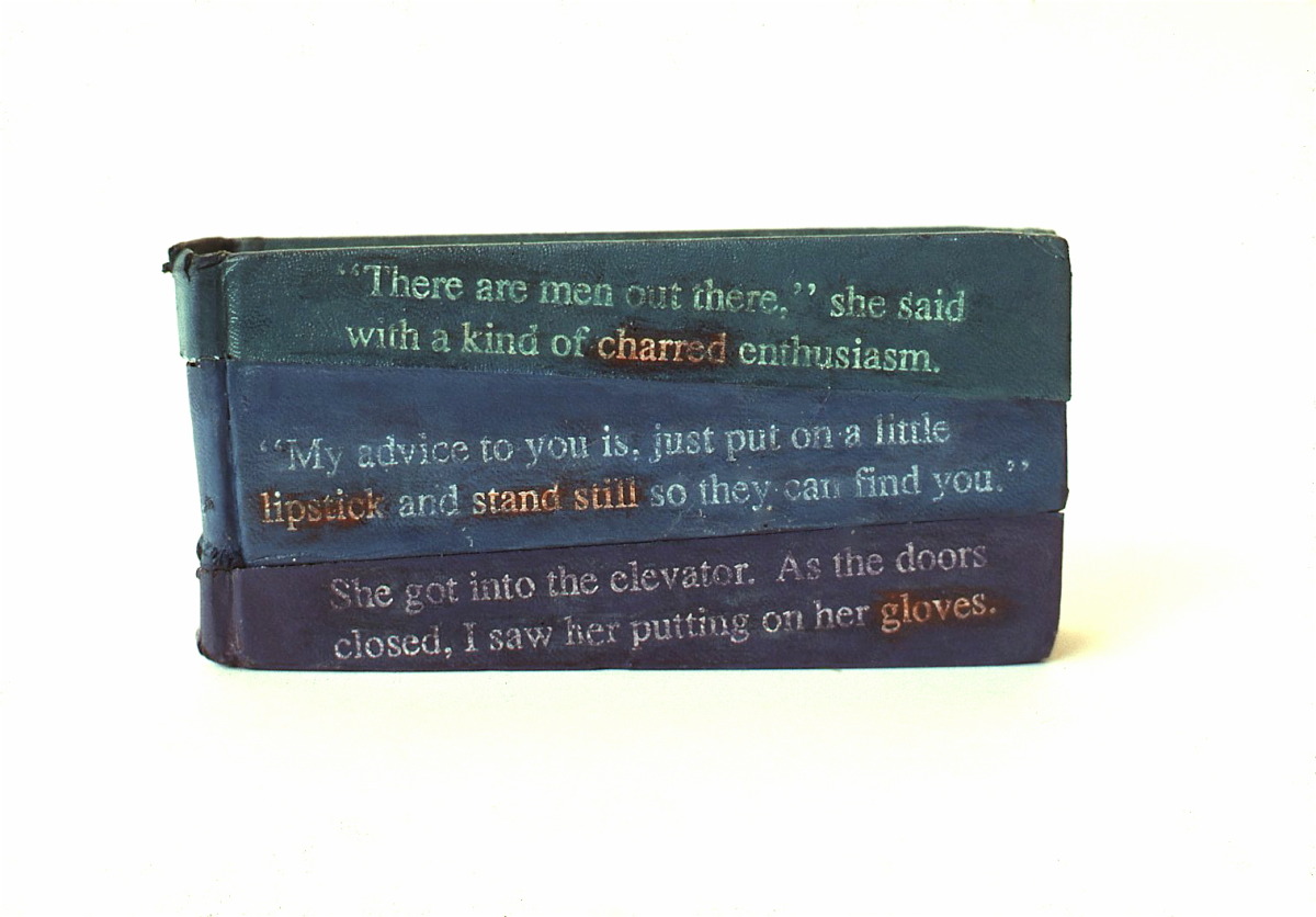 Shortest story , 1989: books, paint, applied text, 3 x 5 x 1inches. Text: "There are men out there,” she said with a kind of charred enthusiasm. “My advice to you is to put on a little lipstick and stand still so they can find you.” She got into the elevator. As the doors closed, I saw her putting on her gloves.