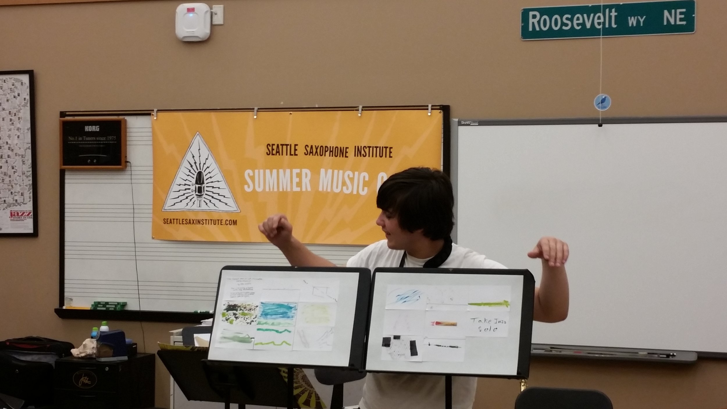  A summer 2016 High School camp attendee displays his "Graphic Score," in which he used found materials from around his house to create a visual composition for the ensemble. 