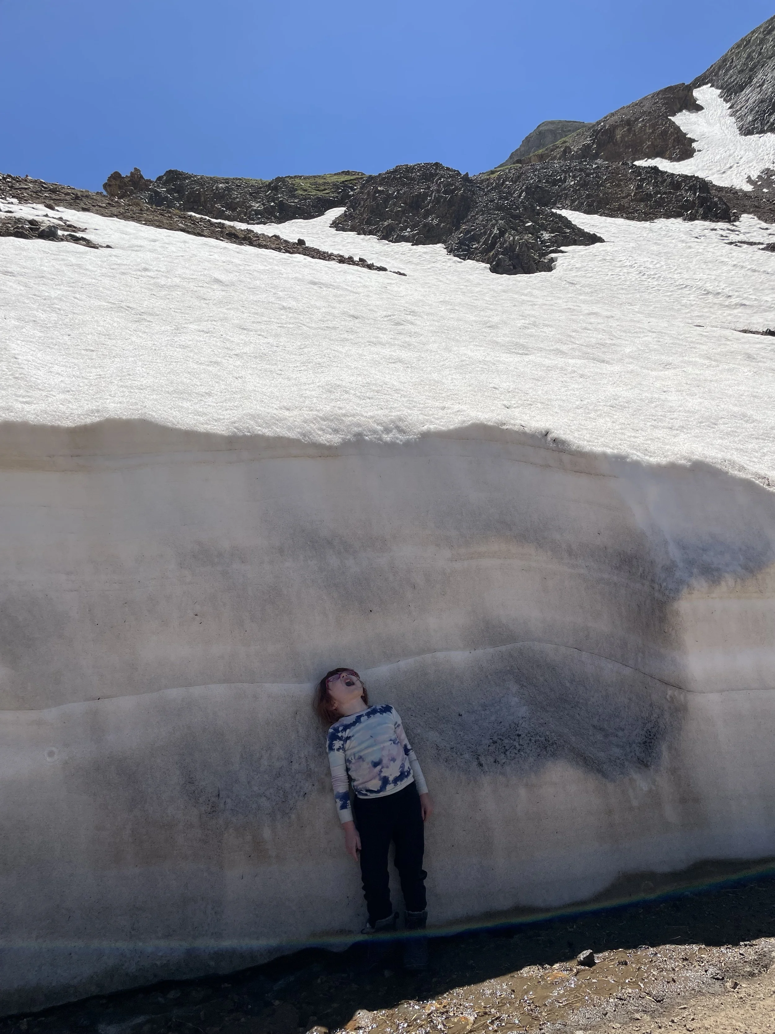 Ella showing us how high the plowed snow was.