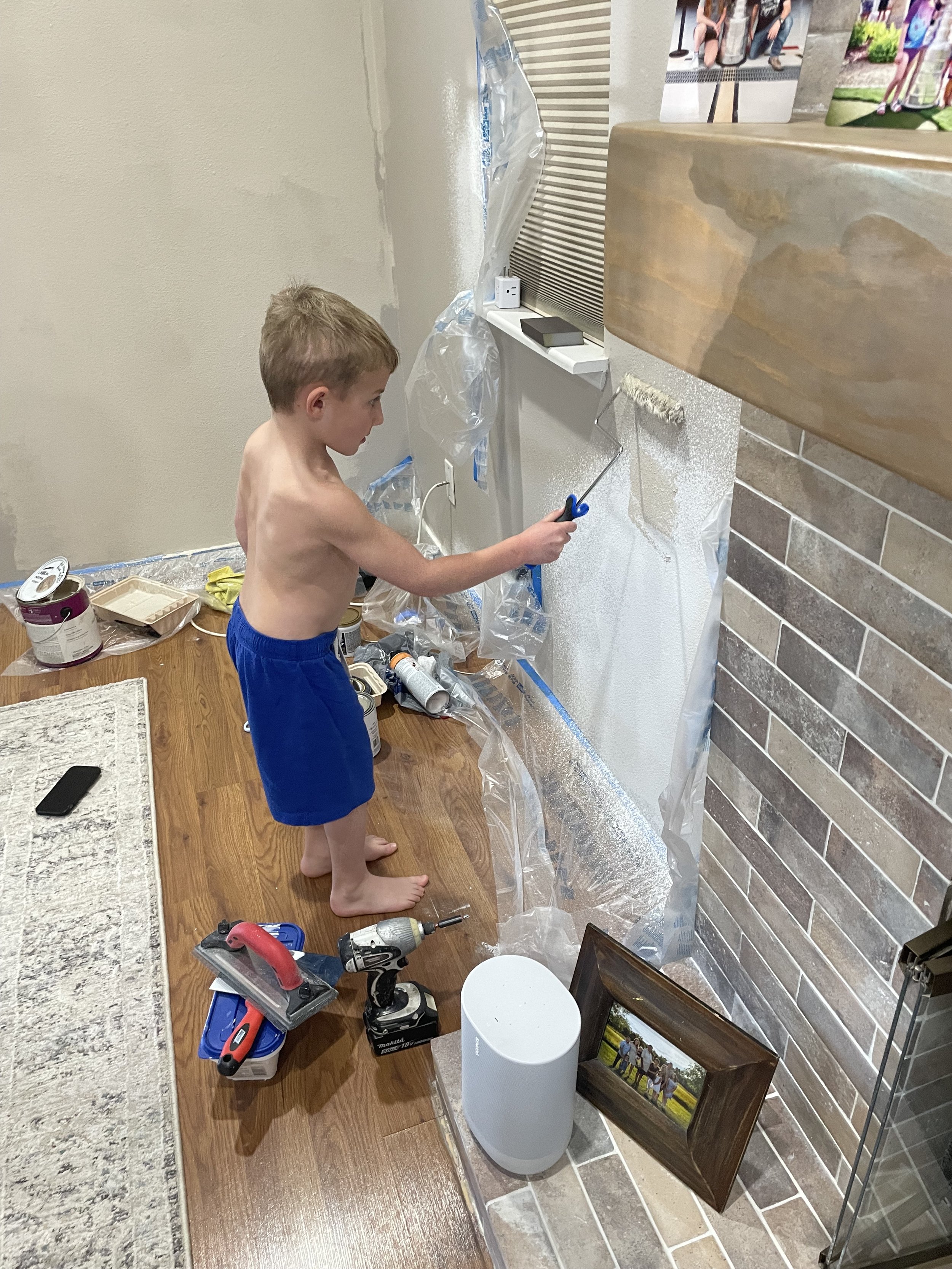 Helping paint the wall where we tore out a speaker