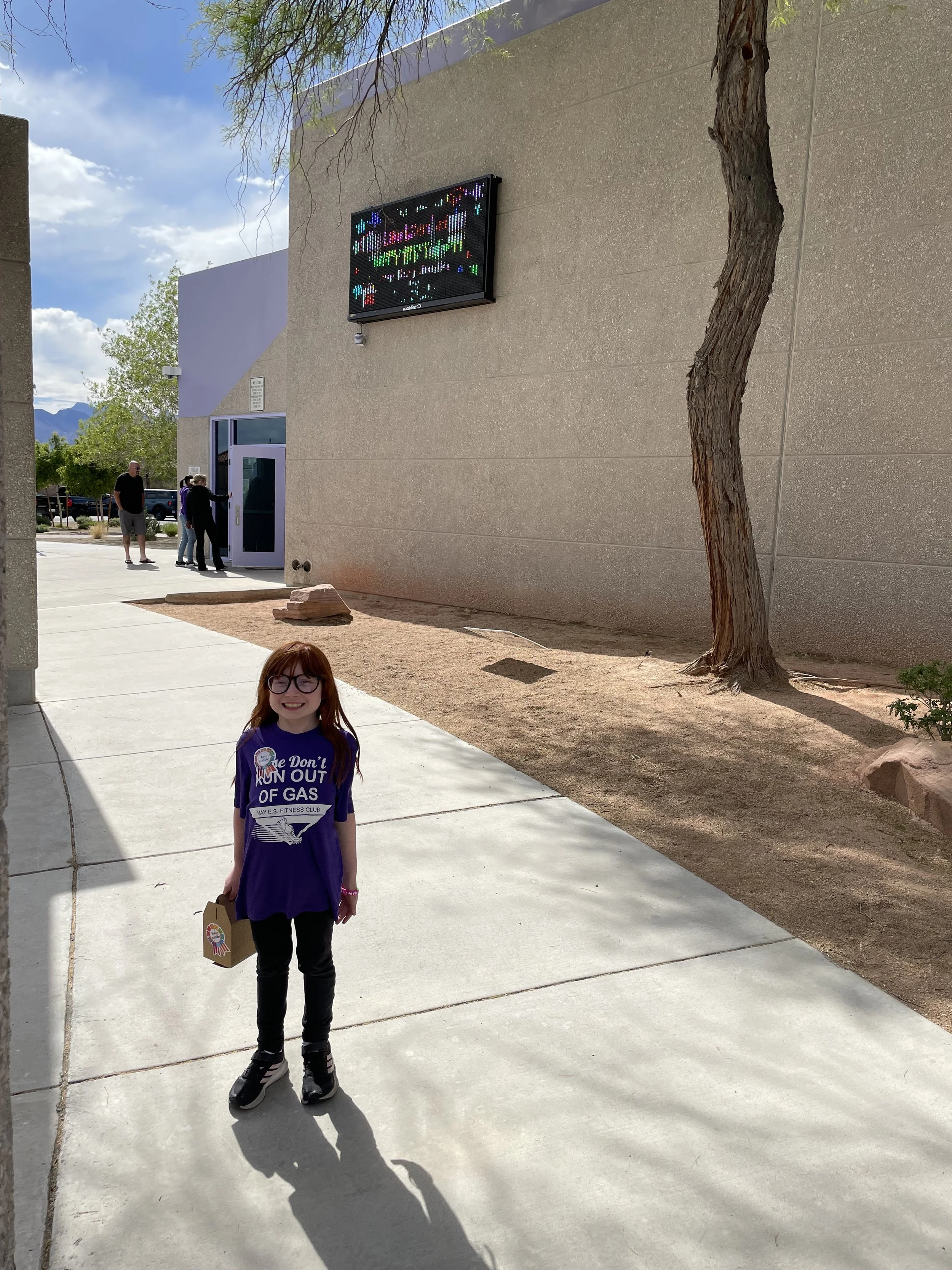 The school sign behind Ella had a birthday shoutout to her!