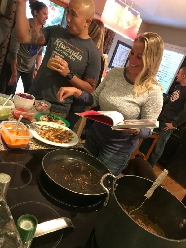 Stephanie seasoning Chrissy Teigen's fish tacos!