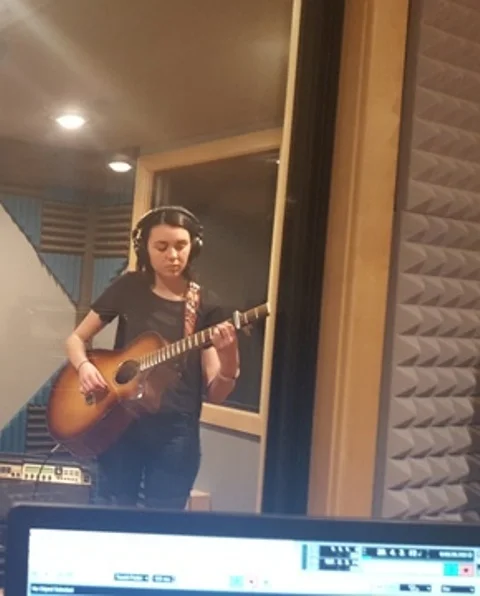 Lake Zurich High School student Olivia jamming with a capo in her guitar lesson recording session with Mike Walsh.