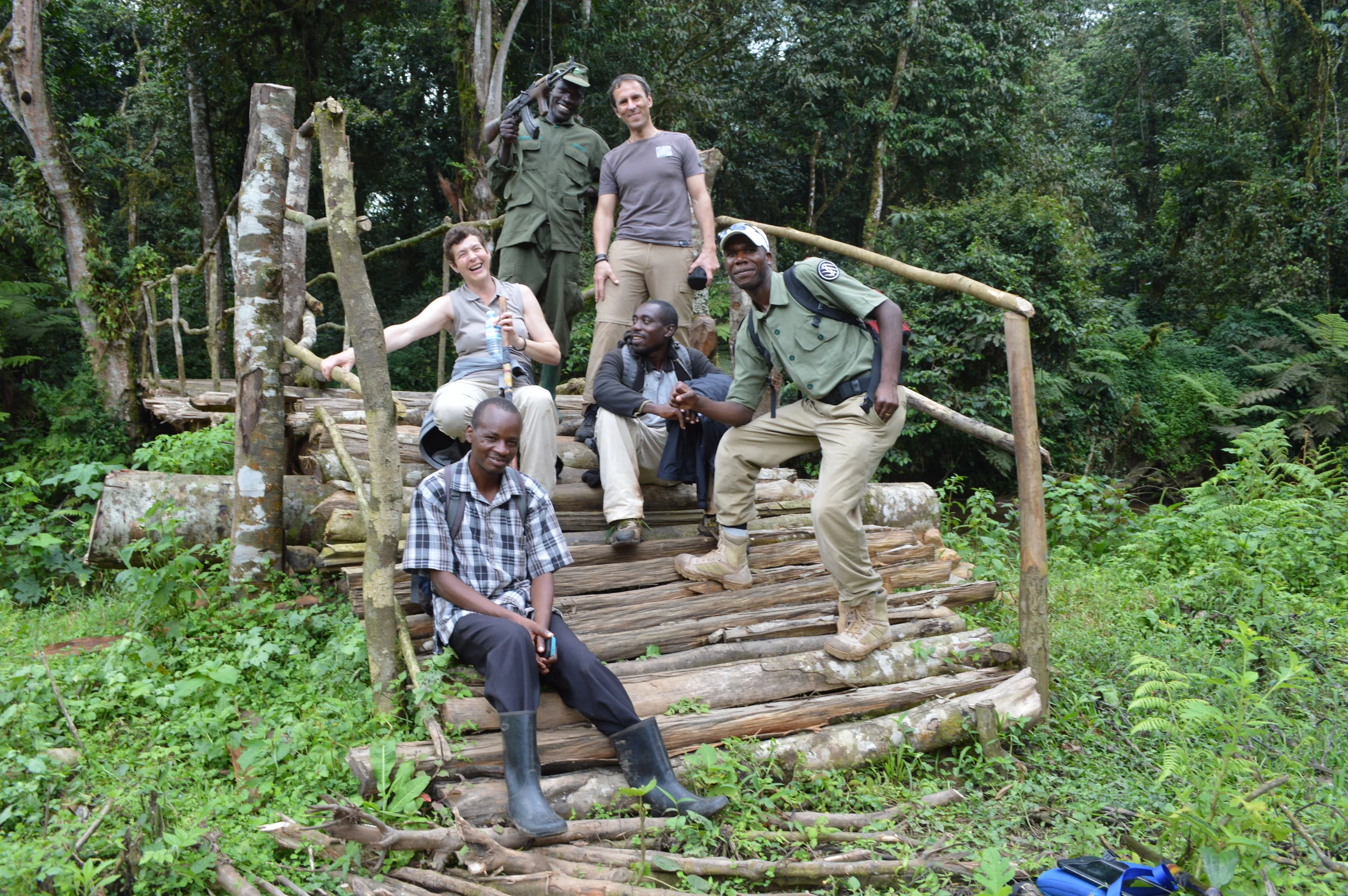 Tourists exiting the forest boundary with rangers,guides,porters and escorts after their whole day experience with Mountain gorillas-Bwindi impenetrable national park.