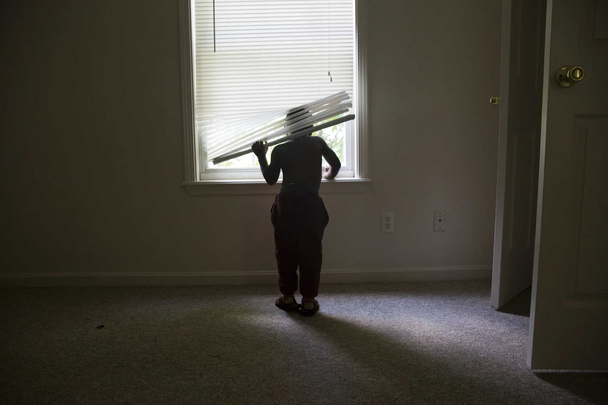 Knova Abshire, 4, explores the bedroom of his late cousin, Dequante Jr. in Louisville, Ky. where they used to play together.