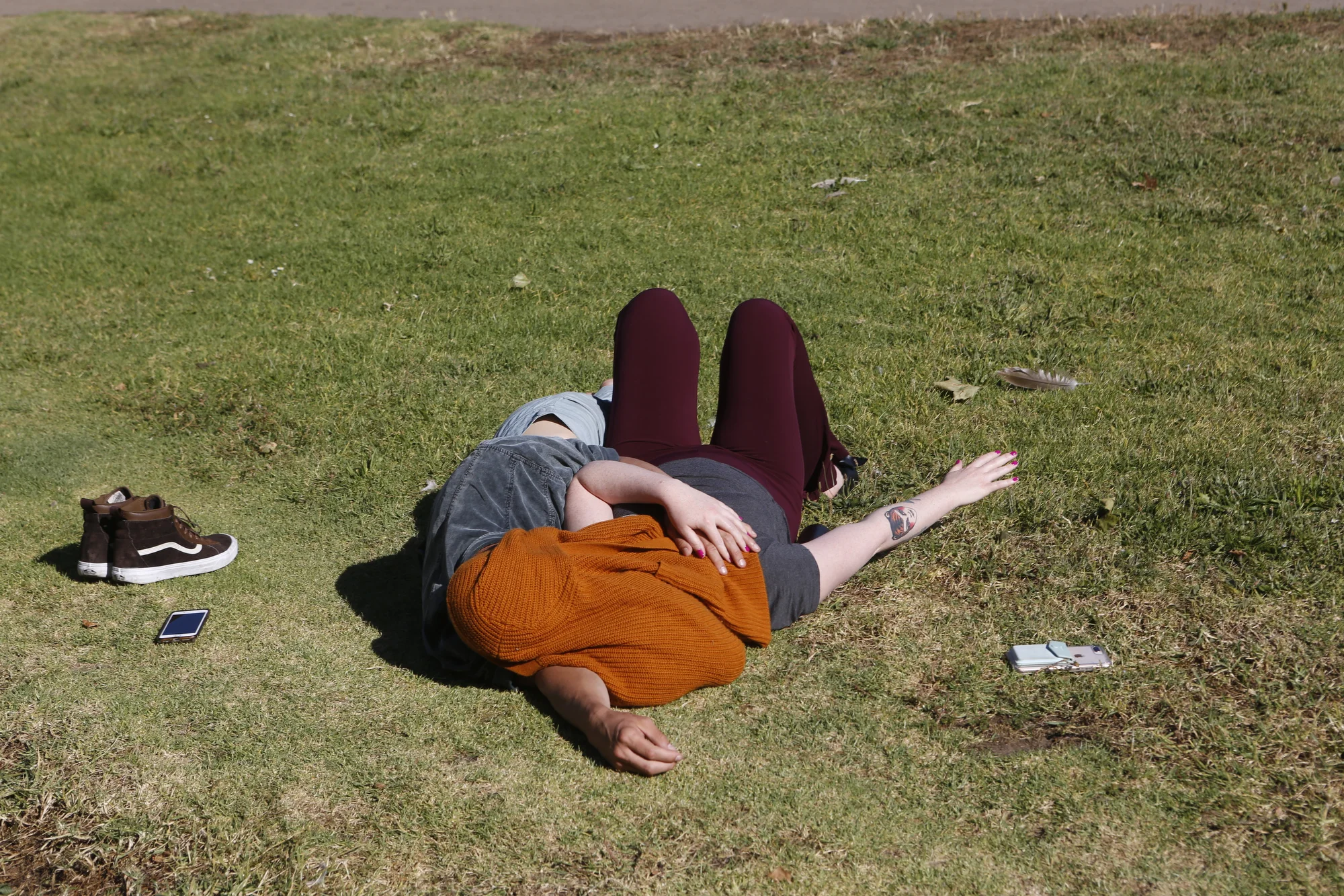  A couple shields themselves from the sun in an embrace at Lake Merritt in Oakland, Calif. 
