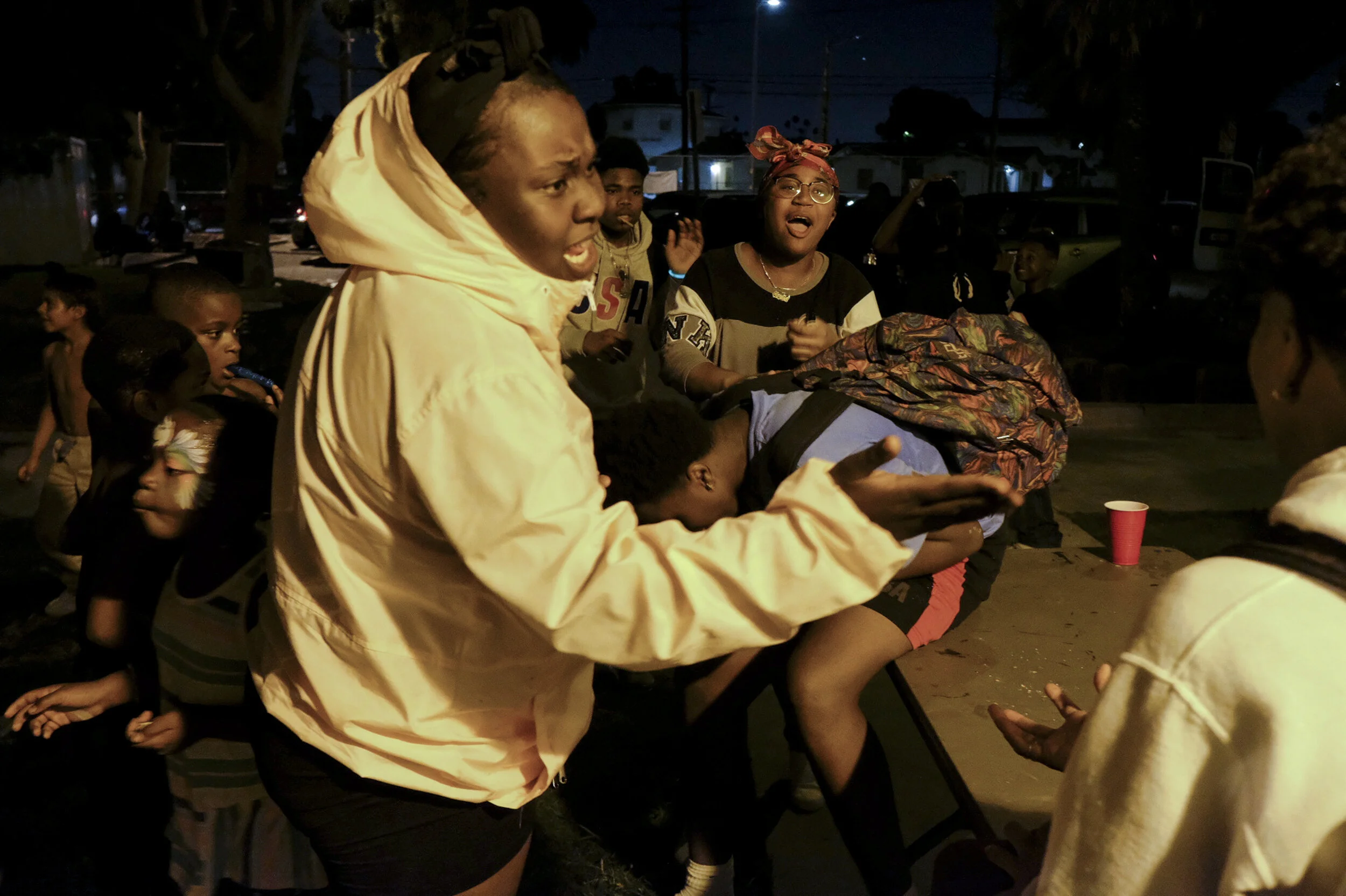  A group of teenagers argues after one of them was slapped. “Some parents drop their kids off for us to babysit and then they go out and party,” says Pastor Tyrice Cagle, a former gang-member turned pastor who is a leader at the park. Other SNL parks