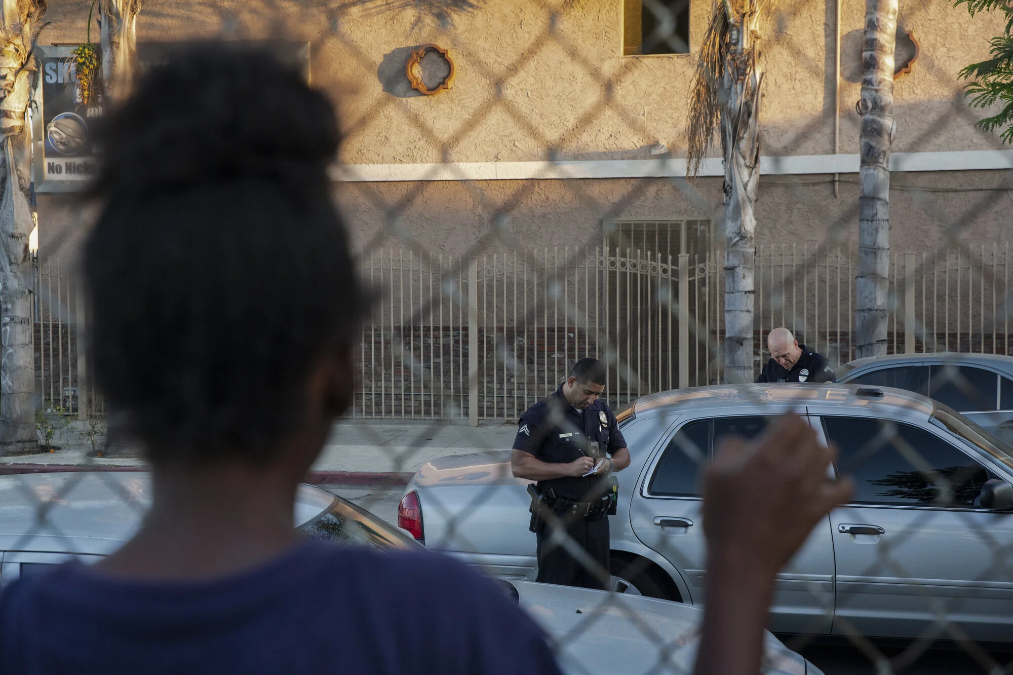  A young girl at SNL watches as officers tow a car. 