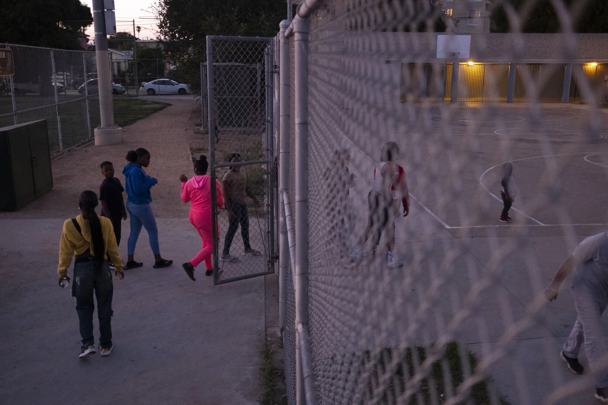  Teenagers enter the park at dusk. Food and activities are provided four evenings a week. 