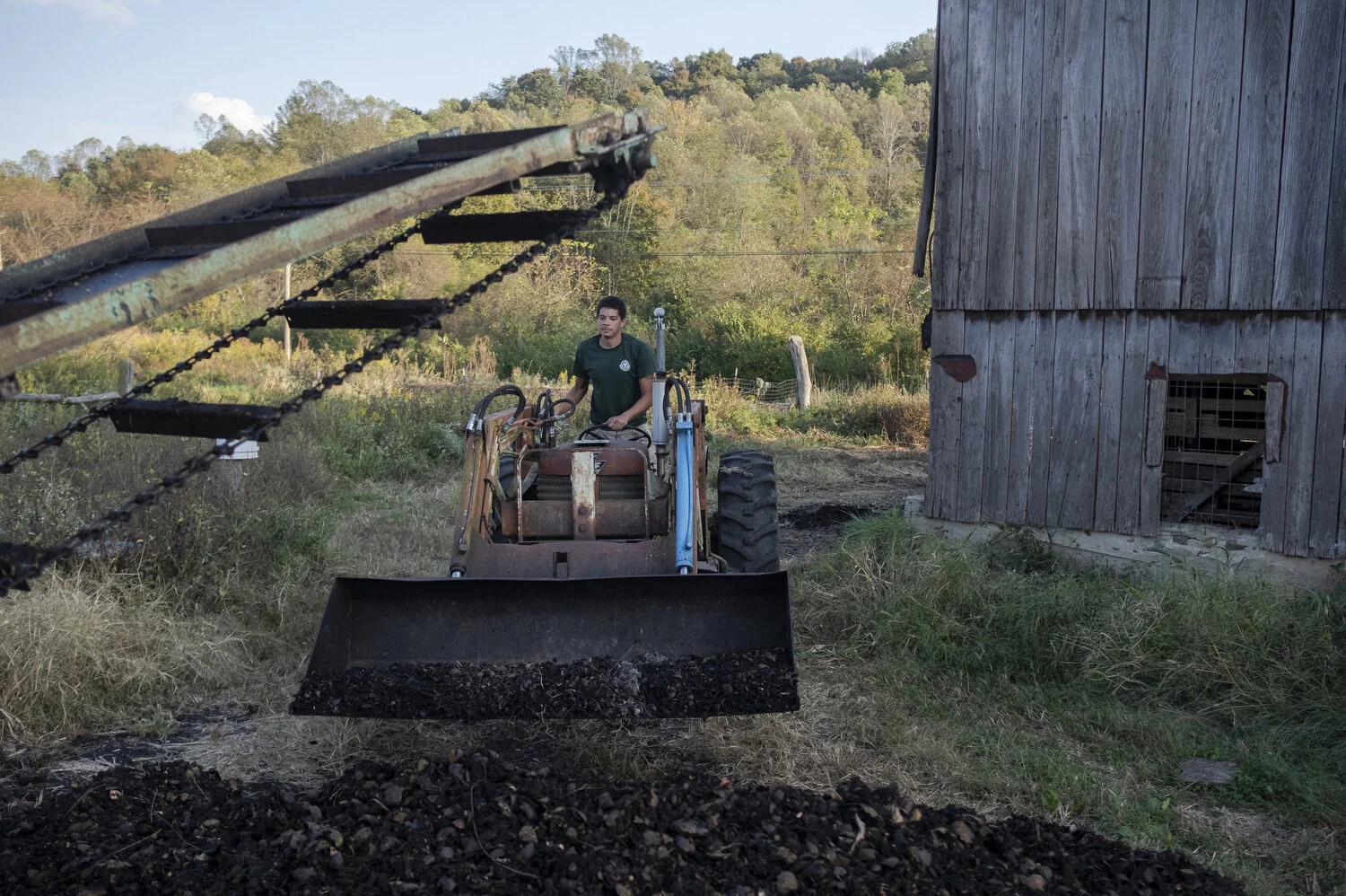  Nate Myers, an employee at the sustainable farm Integration Acres in Albany, Ohio, hulls black walnuts. The farm sells several other products online, but without broadband, productivity is hindered when processing orders and communicating with custo