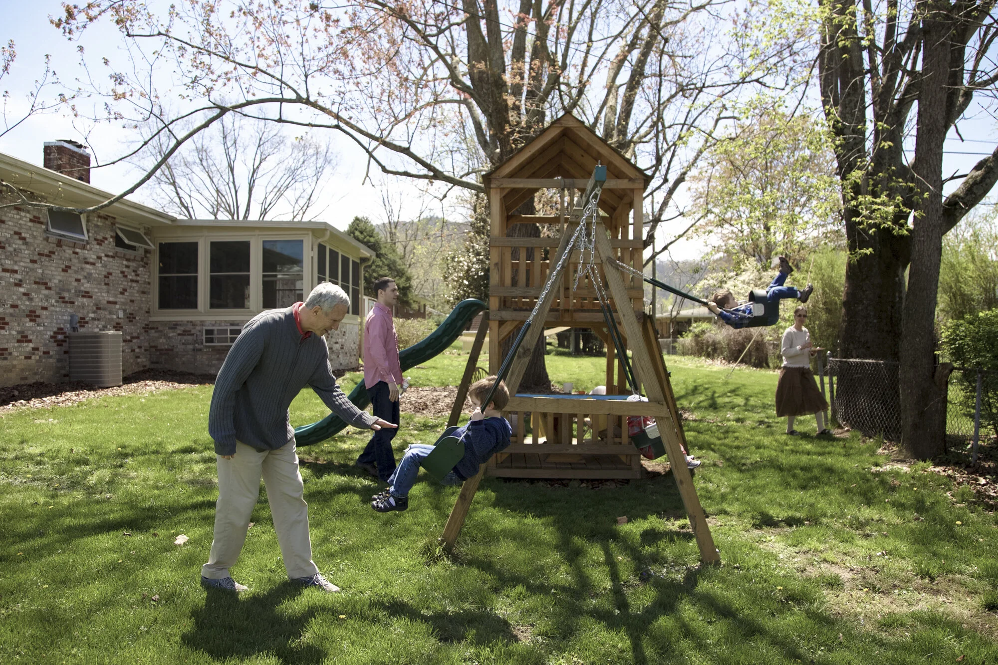  Dr. Moughon and Mary enjoy a visit with their grandchildren at the same house in which they raised their family. They have six sons, two daughters, and eight grandchildren.  