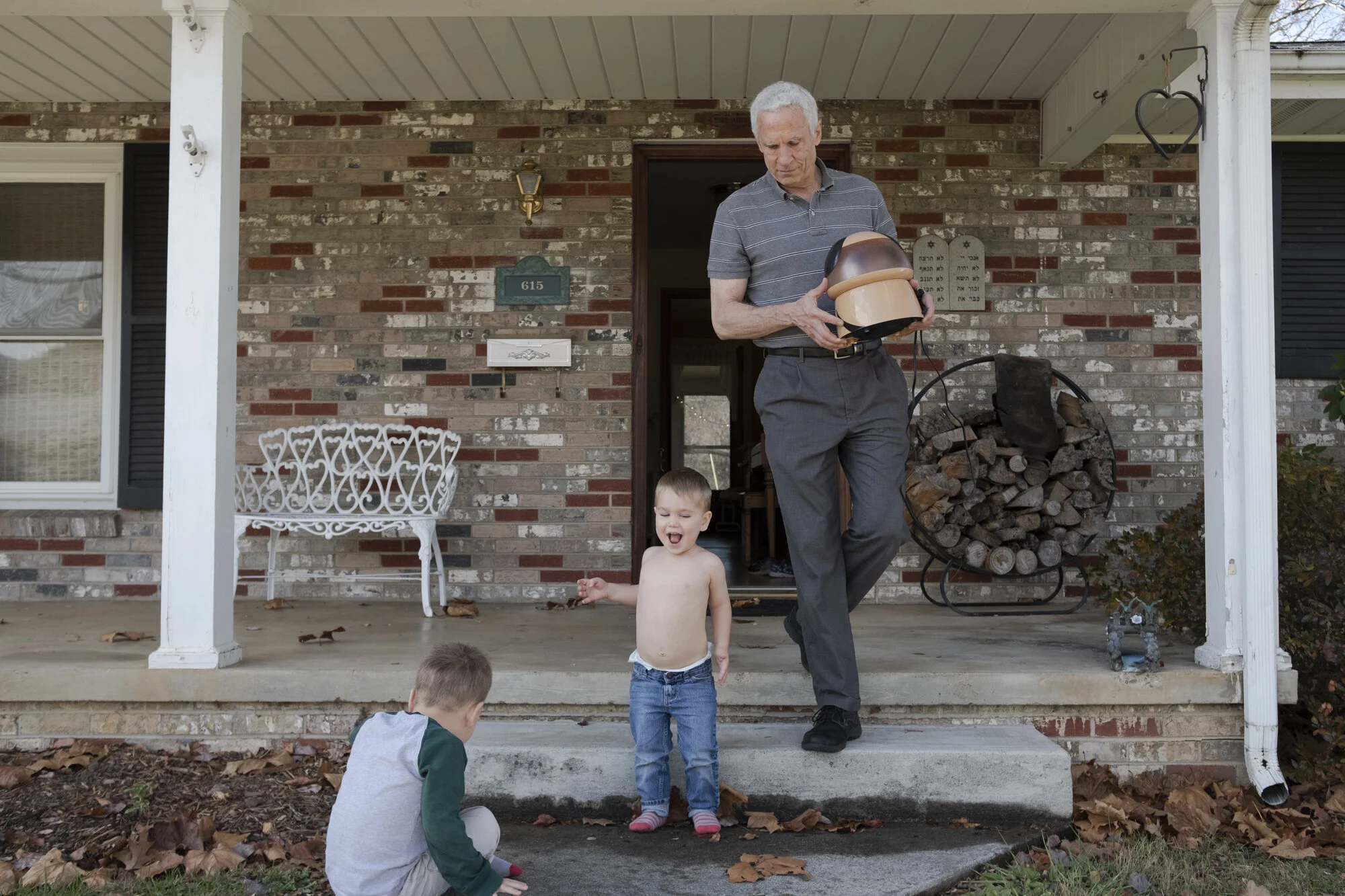  Grandsons William, left, and George, center, play as Dr. Moughon packs the car for their Thanksgiving holiday where all eight children, two parents, three in-laws, and eight grandchildren will gather. 