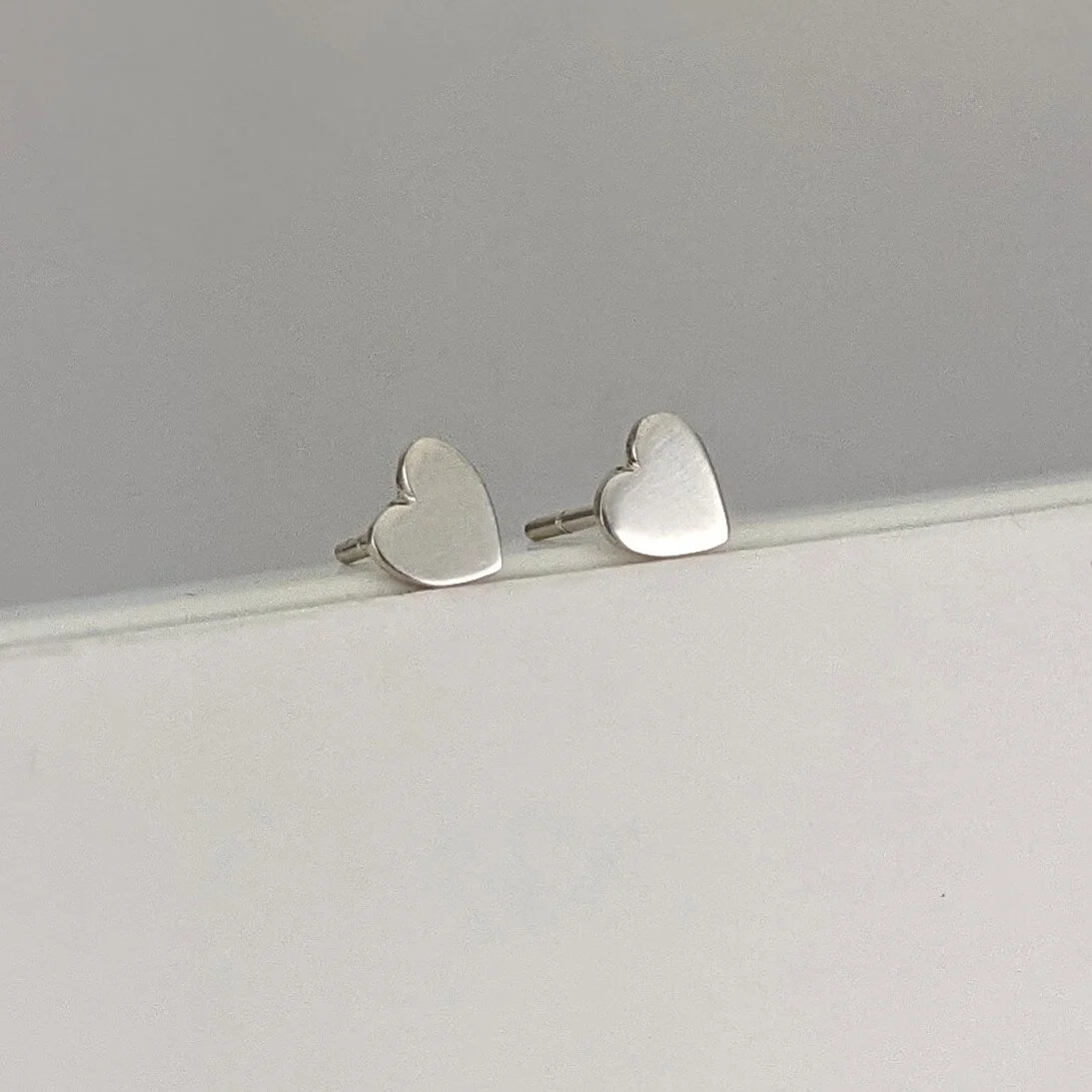 Tiny hand-cut heart studs