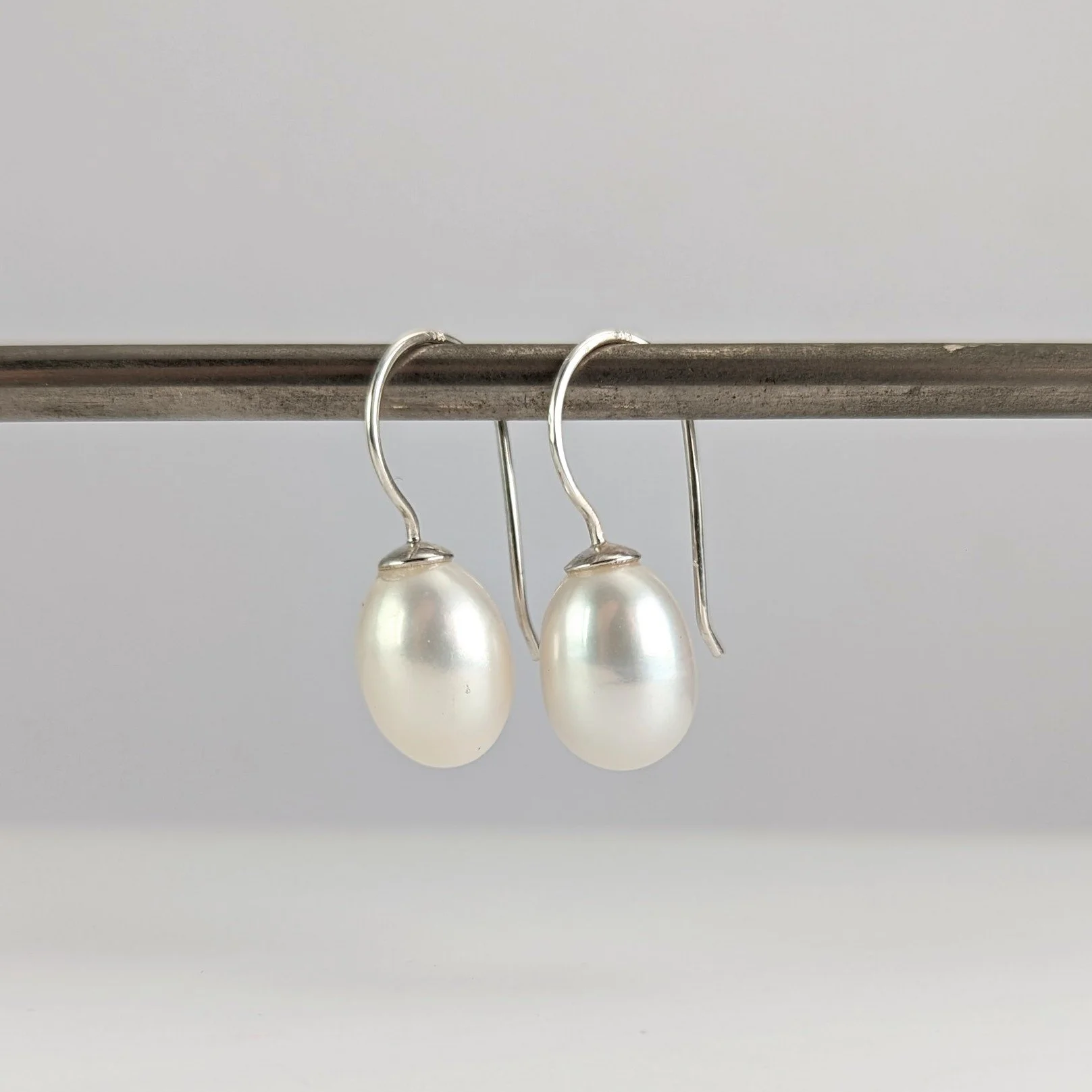 Large half drilled white oval shaped pearl earrings